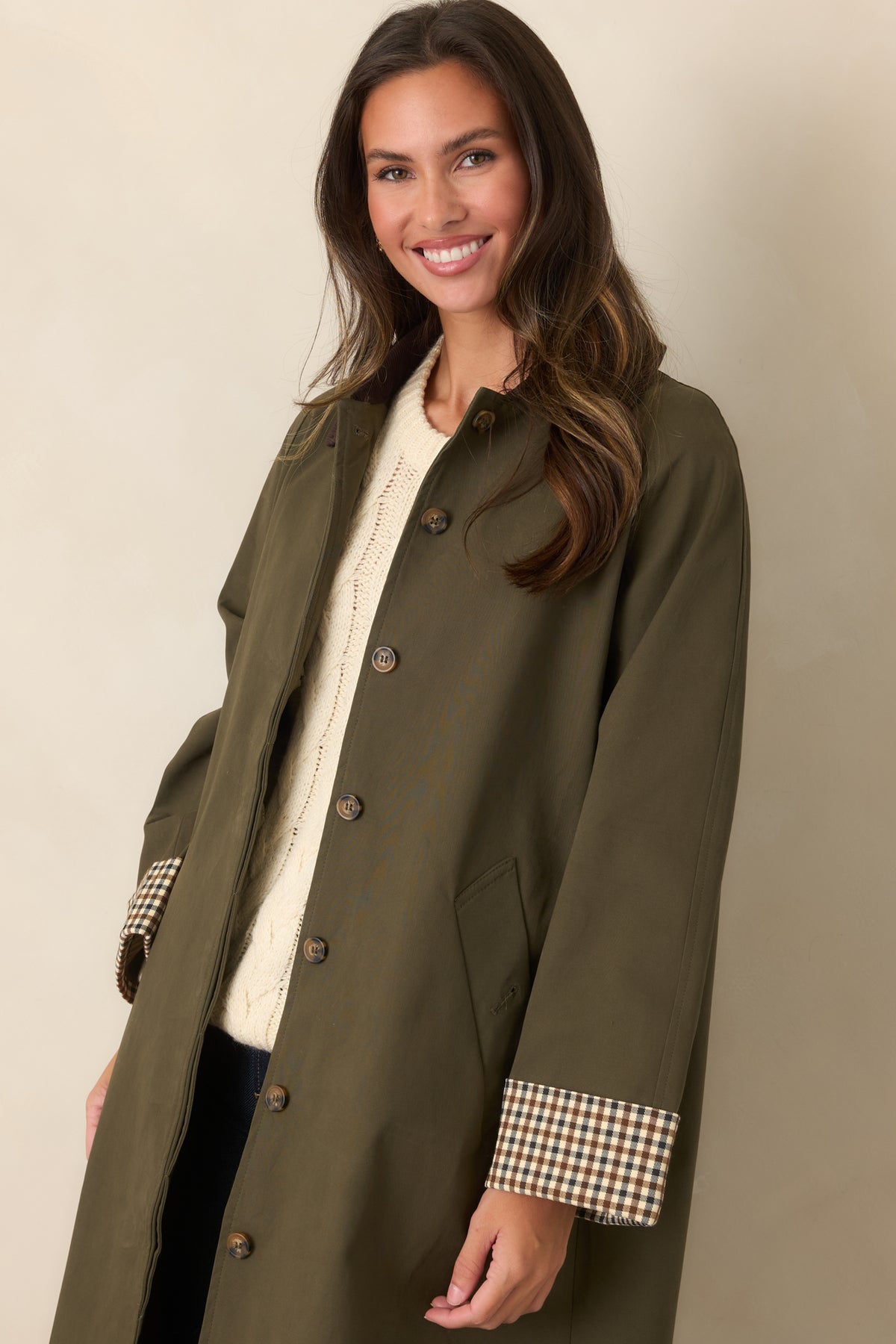 Coat featuring a coordinating tie belt and chocolate brown corduroy collar against smooth canvas-feel fabric.