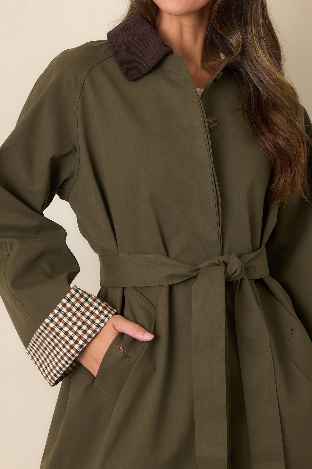 Detail of the coordinating tie belt and smooth canvas-feel fabric on the coat.