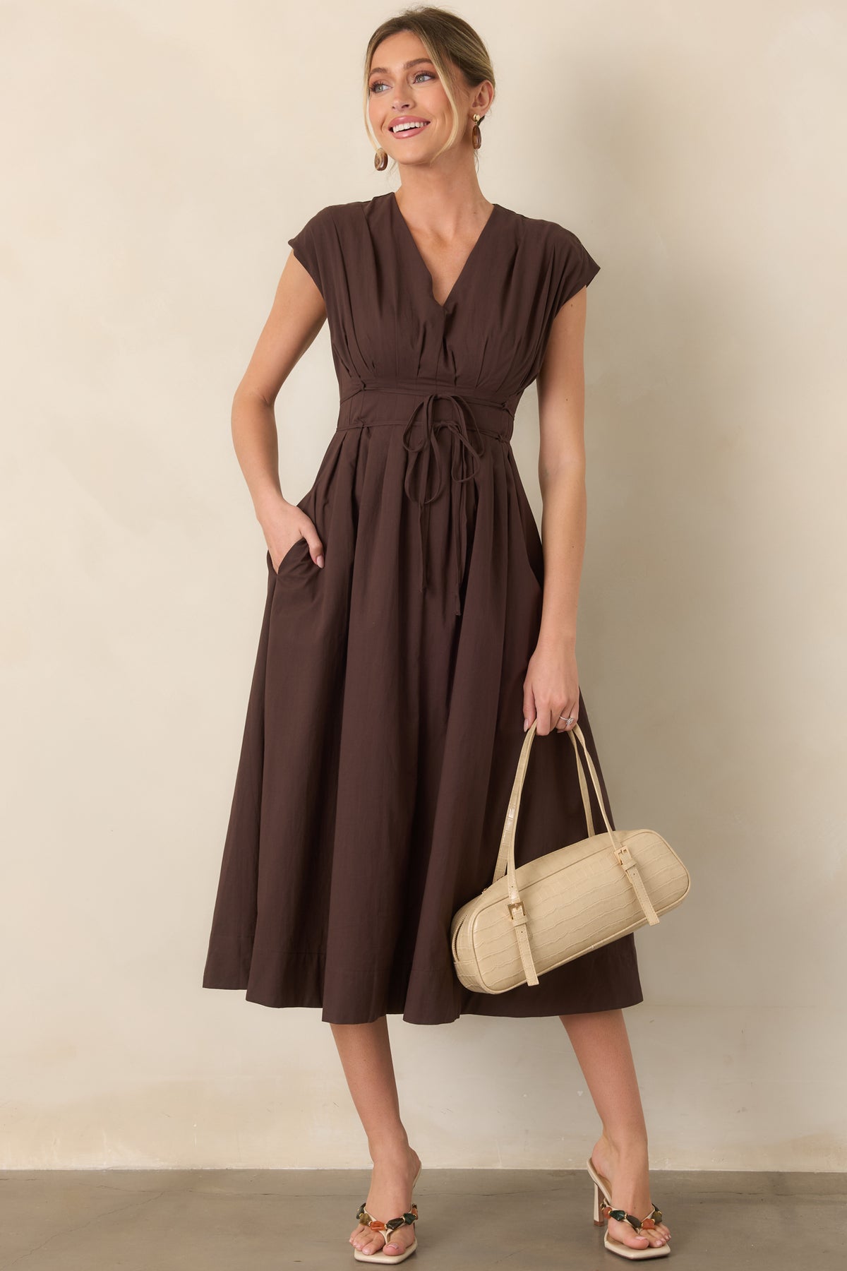 Elegant midi dress featuring delicate cap sleeves, a defined waist with a double strand tie belt, and a softly gathered skirt.