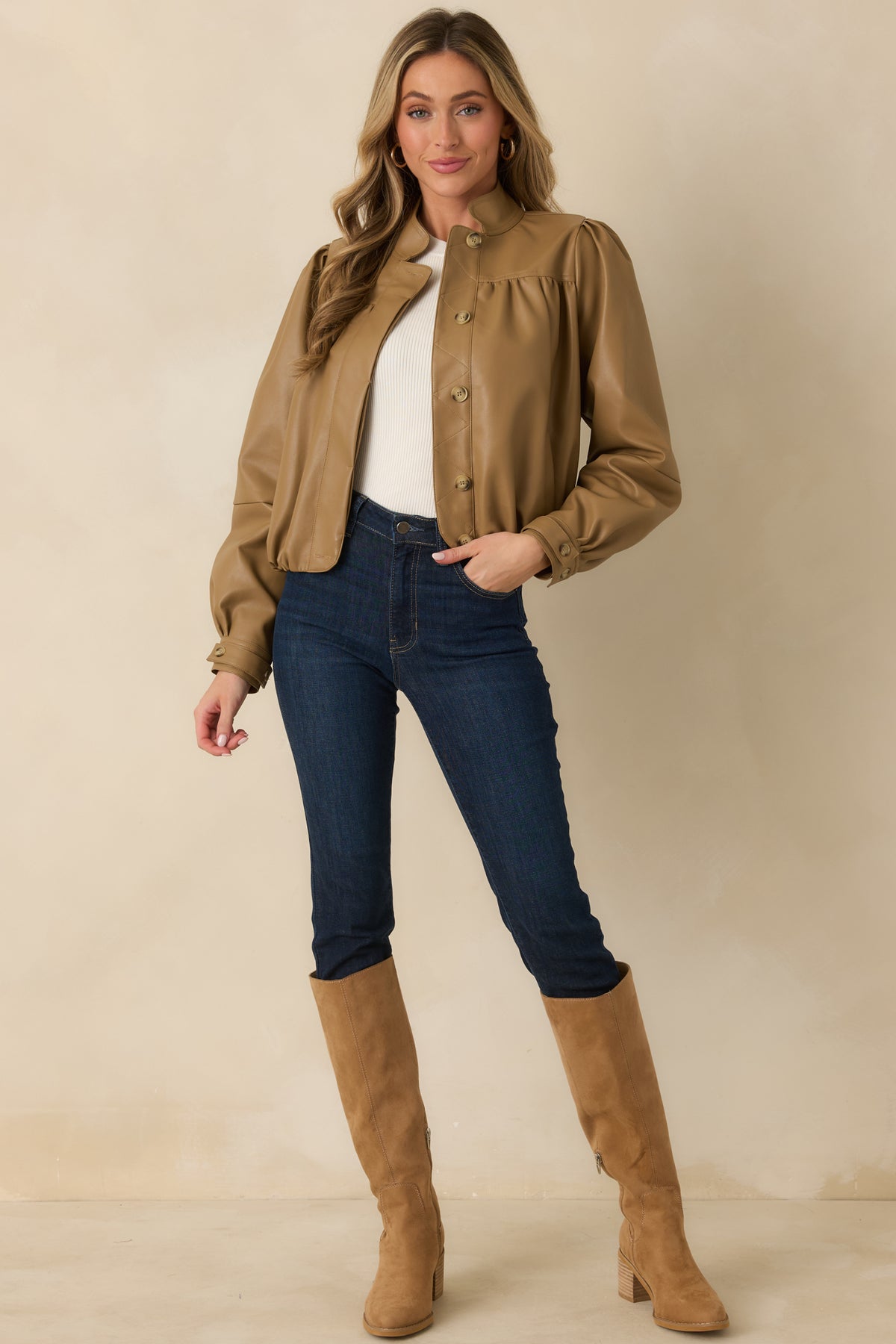 Caramel vegan leather jacket featuring a rounded stand collar, button-front closure, long puff sleeves, and an elasticized hem.