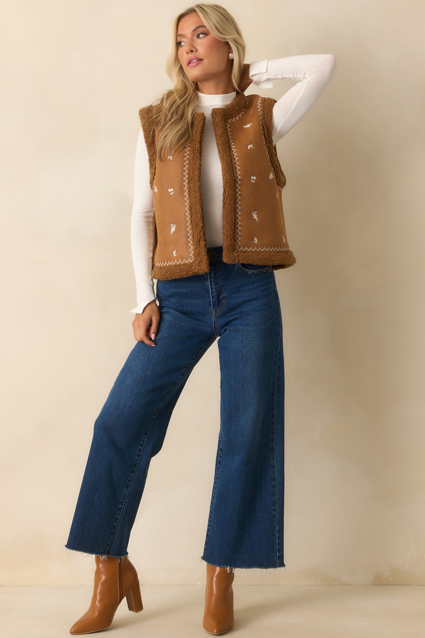 Caramel vest with embroidered floral details, open front design, and relaxed straight silhouette.