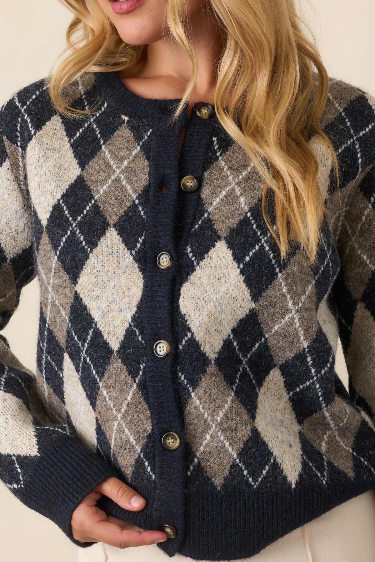 Close detail of the cardigan showing its diamond knit texture, fine white lines, and softly brushed finish.