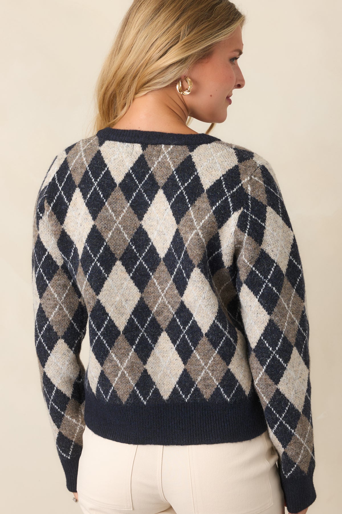 Rear of the navy, taupe, and ivory cardigan showcasing the repeating diamond pattern and relaxed knit silhouette.