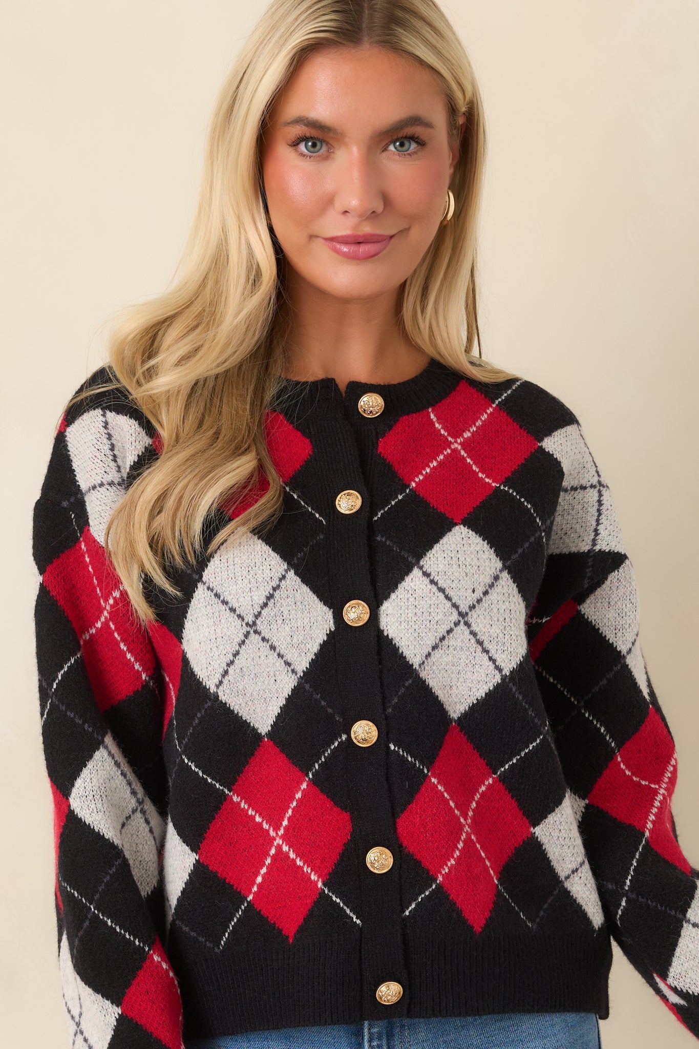 The front of this cardigan highlights the colorful argyle pattern and decorative gold-tone buttons.