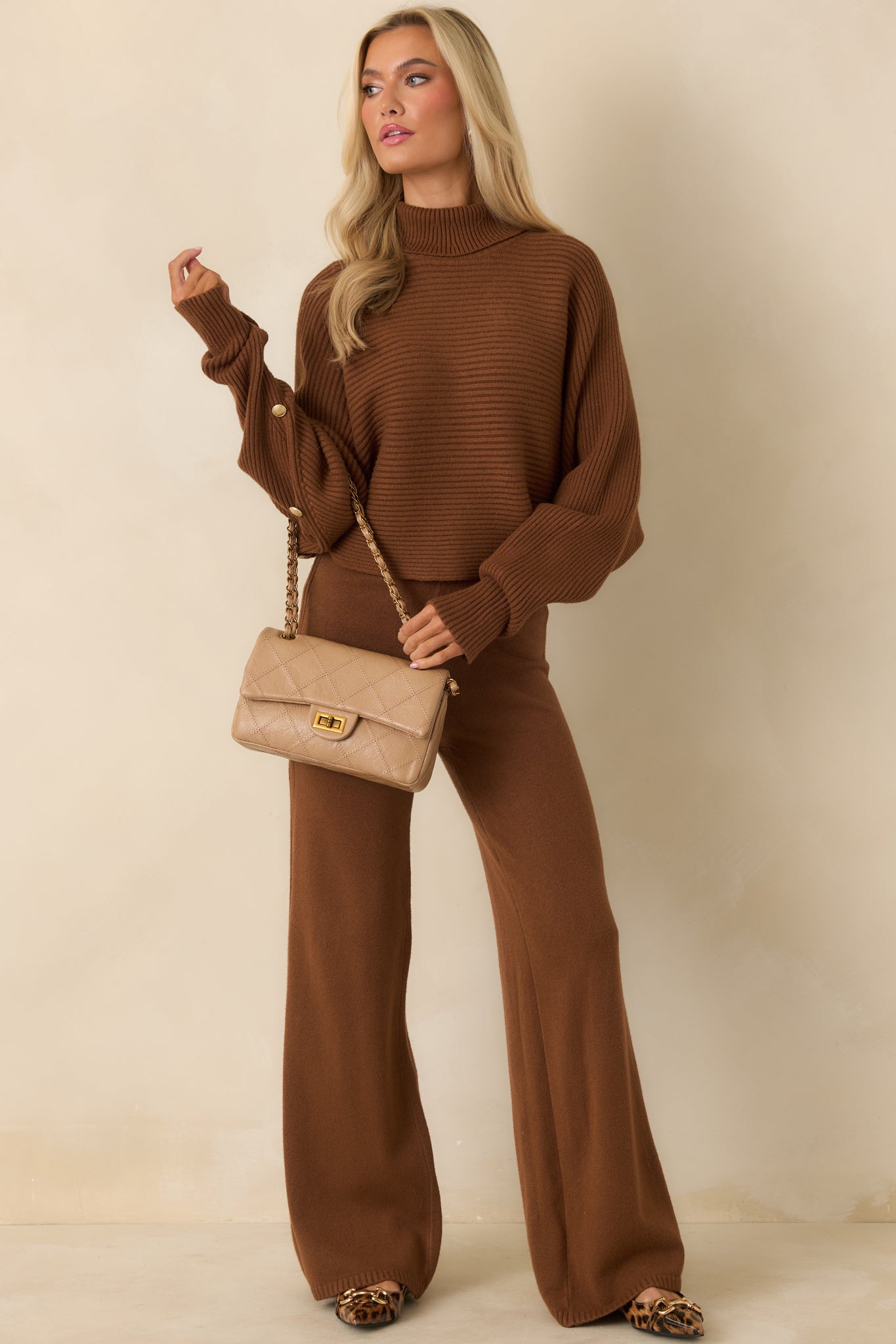 Casual brown turtleneck sweater with a loose, relaxed fit and long sleeves.