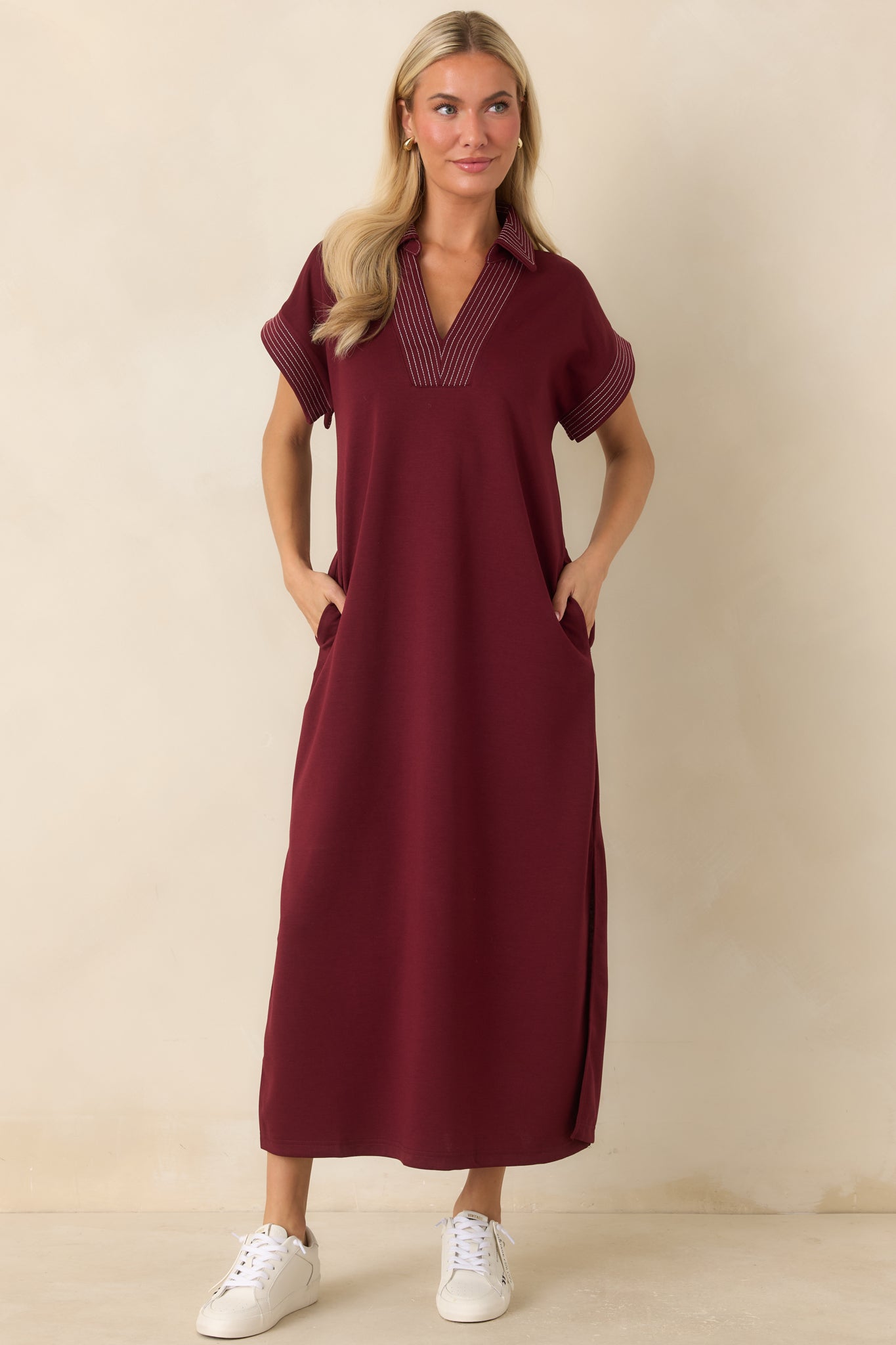 Casual collared dress showcasing a loose shape, functional side pockets, and easy styling.