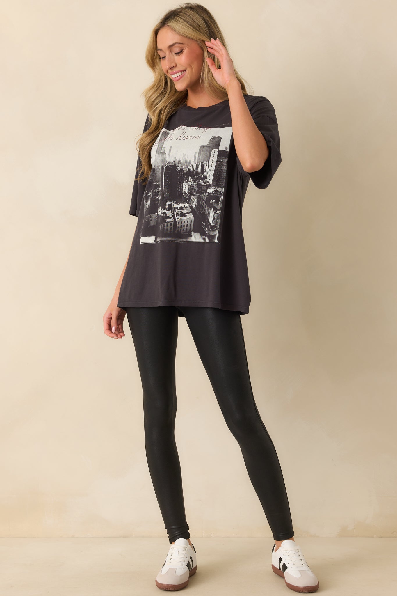 Casual short-sleeve black tee with a crew neckline and embroidered “from the city with love” detail.