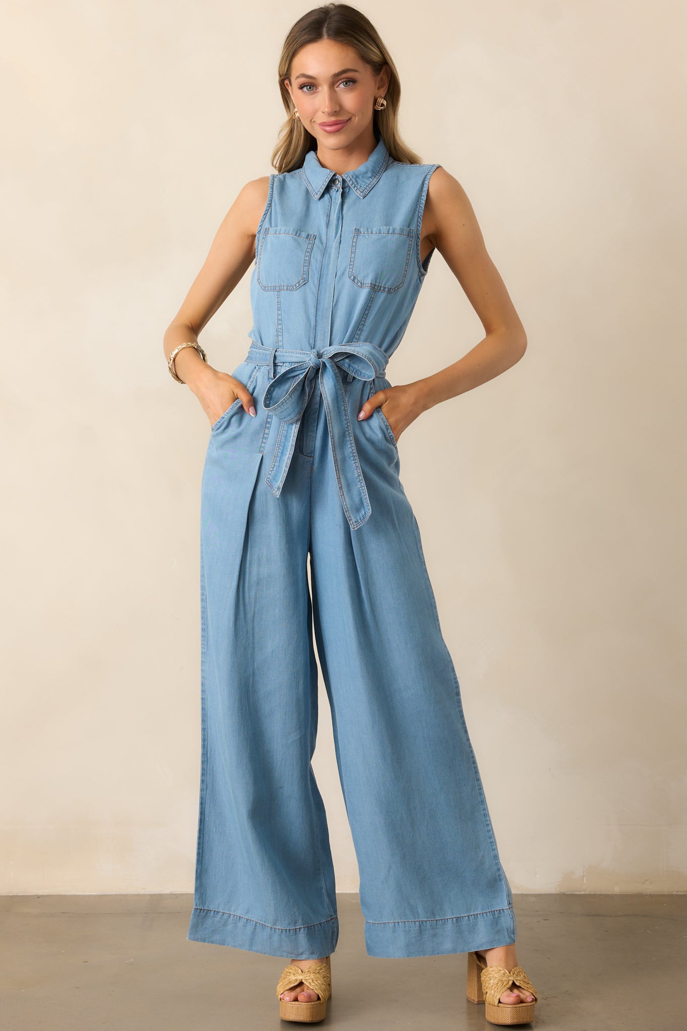 A modern chambray jumpsuit with a zip-front closure, wide-leg design, and a cinched waist for a flattering fit.