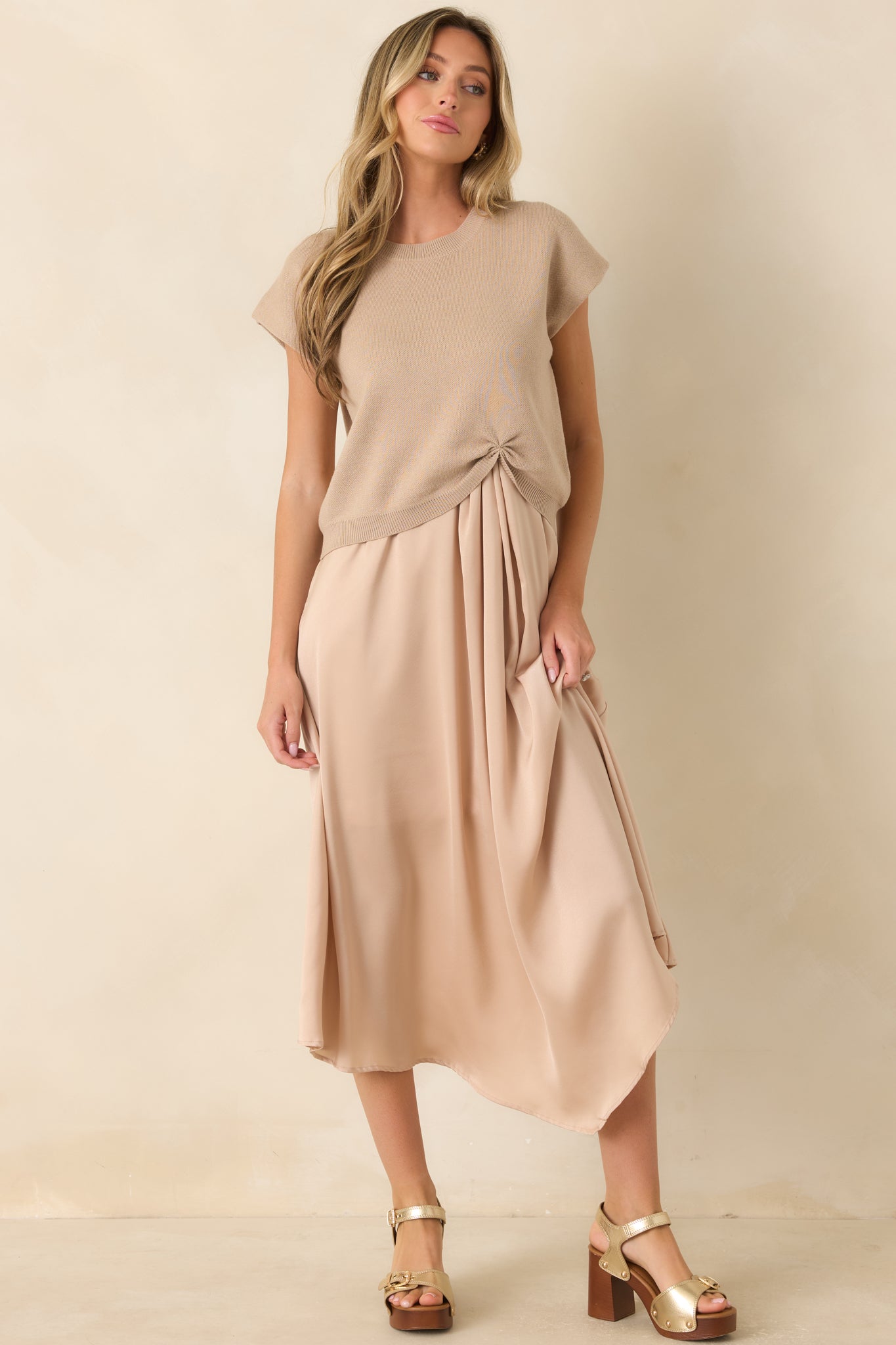 Champagne midi dress featuring a classic scoop neckline, elegant sleeveless silhouette, and a softly flowing lined satin skirt.
