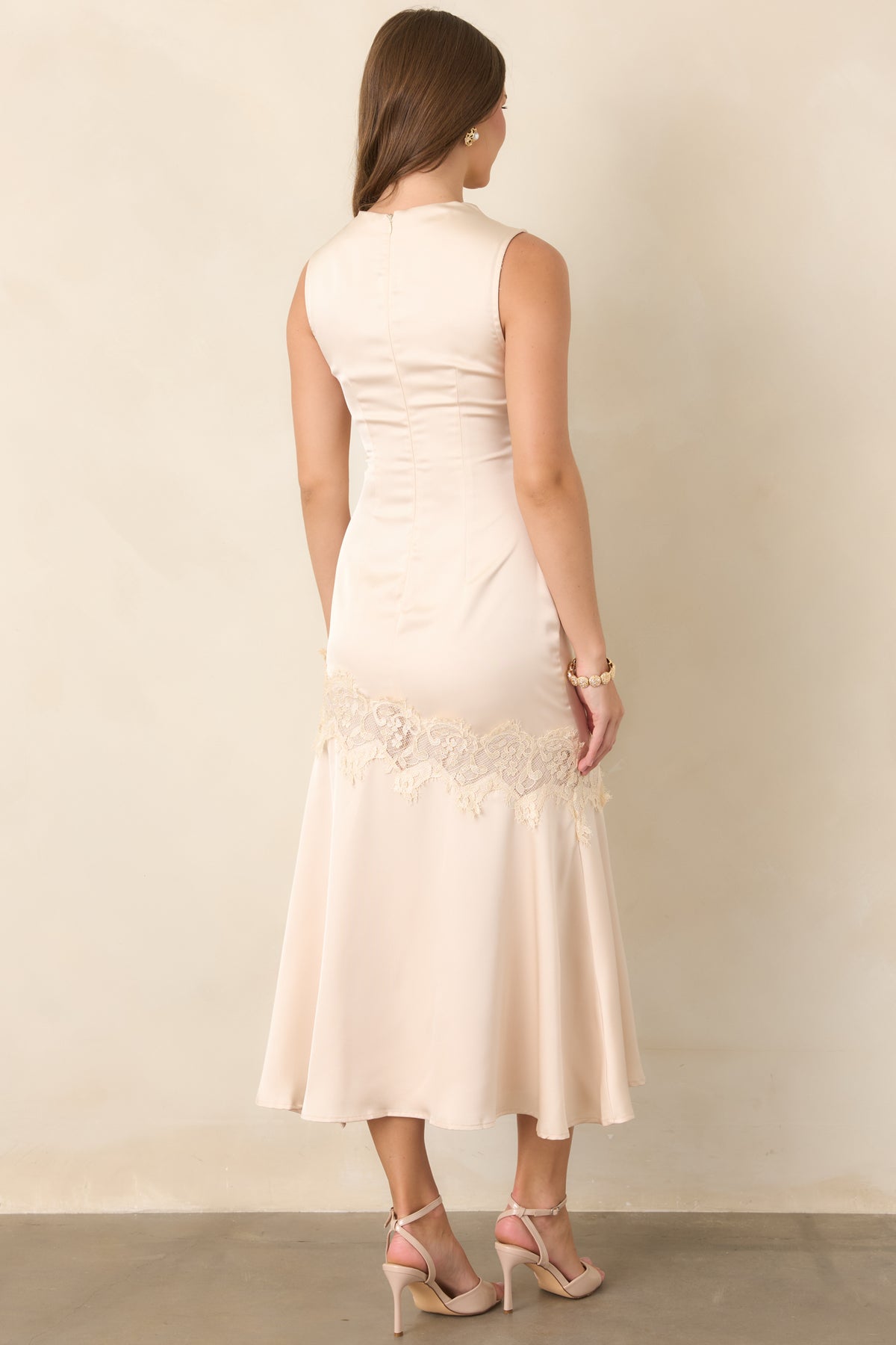 Rear view of the champagne satin midi dress showing its clean fitted silhouette and concealed zipper closure.