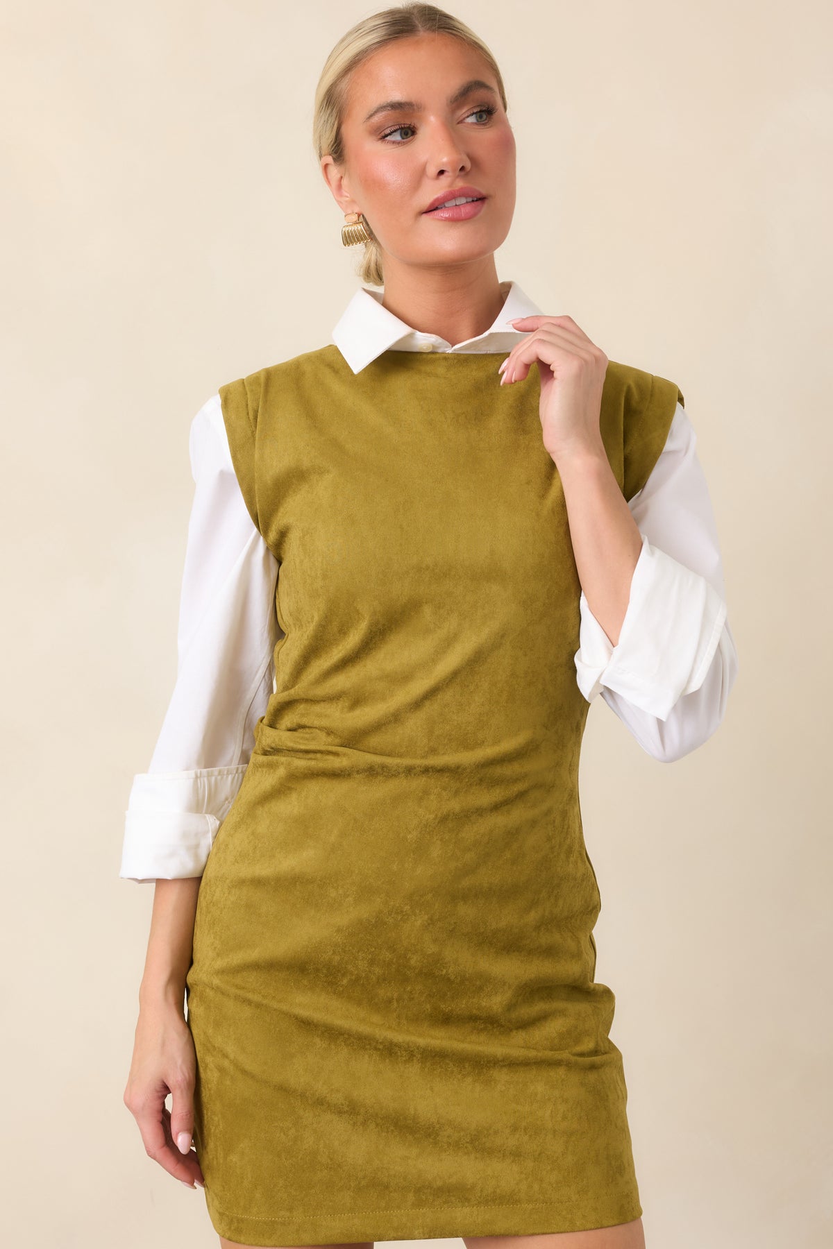 Fitted faux suede-like mini dress showcasing the smooth texture and softly draped waist.
