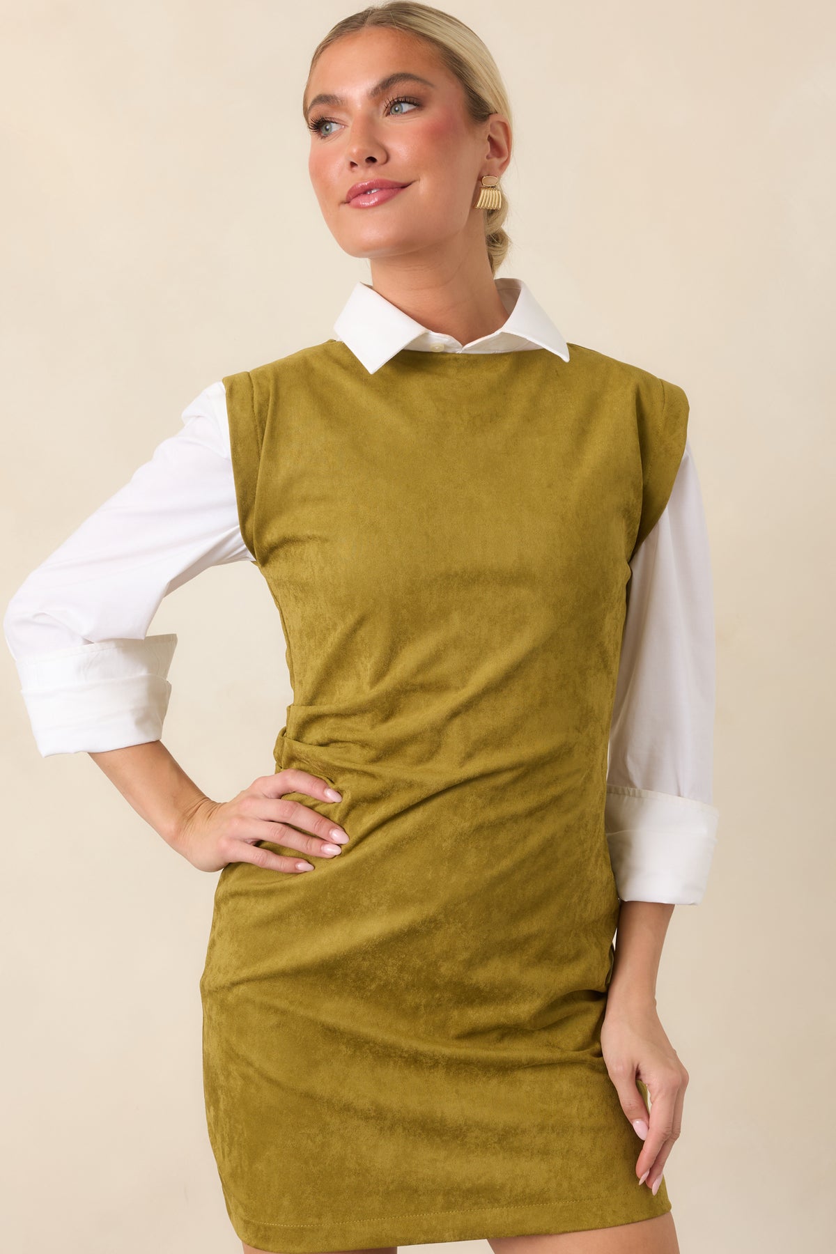 Close view of the chartreuse faux suede-like fabric, round neckline, and wide shoulder design.
