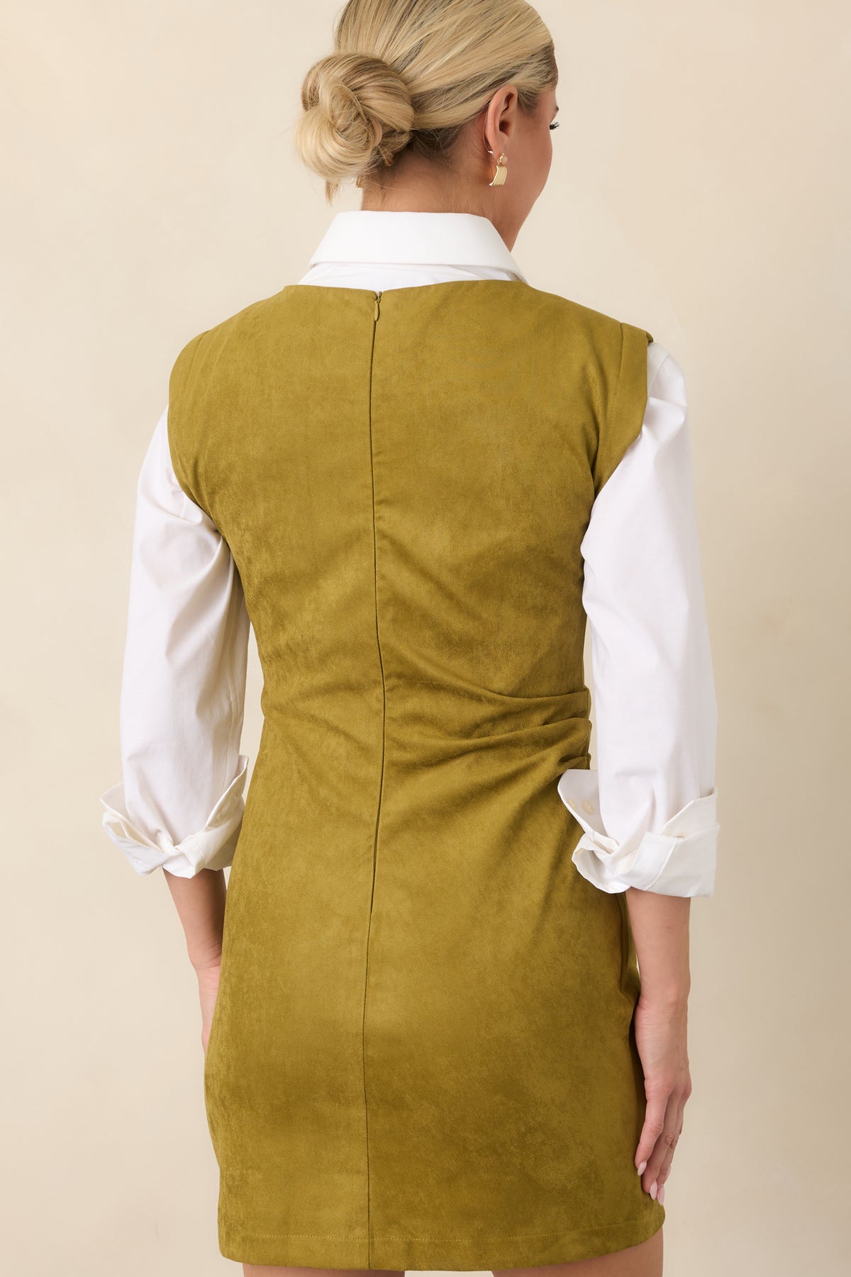 Rear of the chartreuse fitted mini dress showing the concealed back zipper and smooth lined construction.
