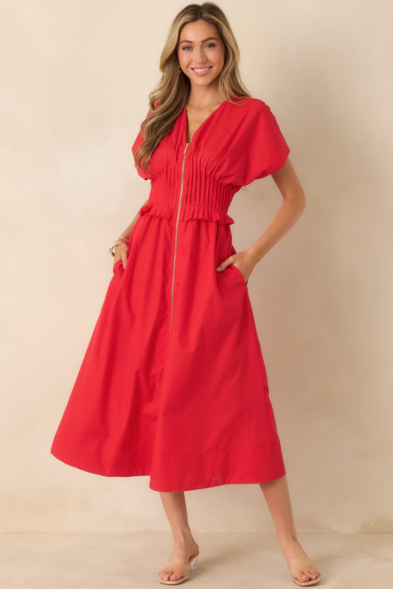 Relaxed cherry red maxi dress featuring a wide smocked waistband with delicate ruffled trim and side seam pockets.