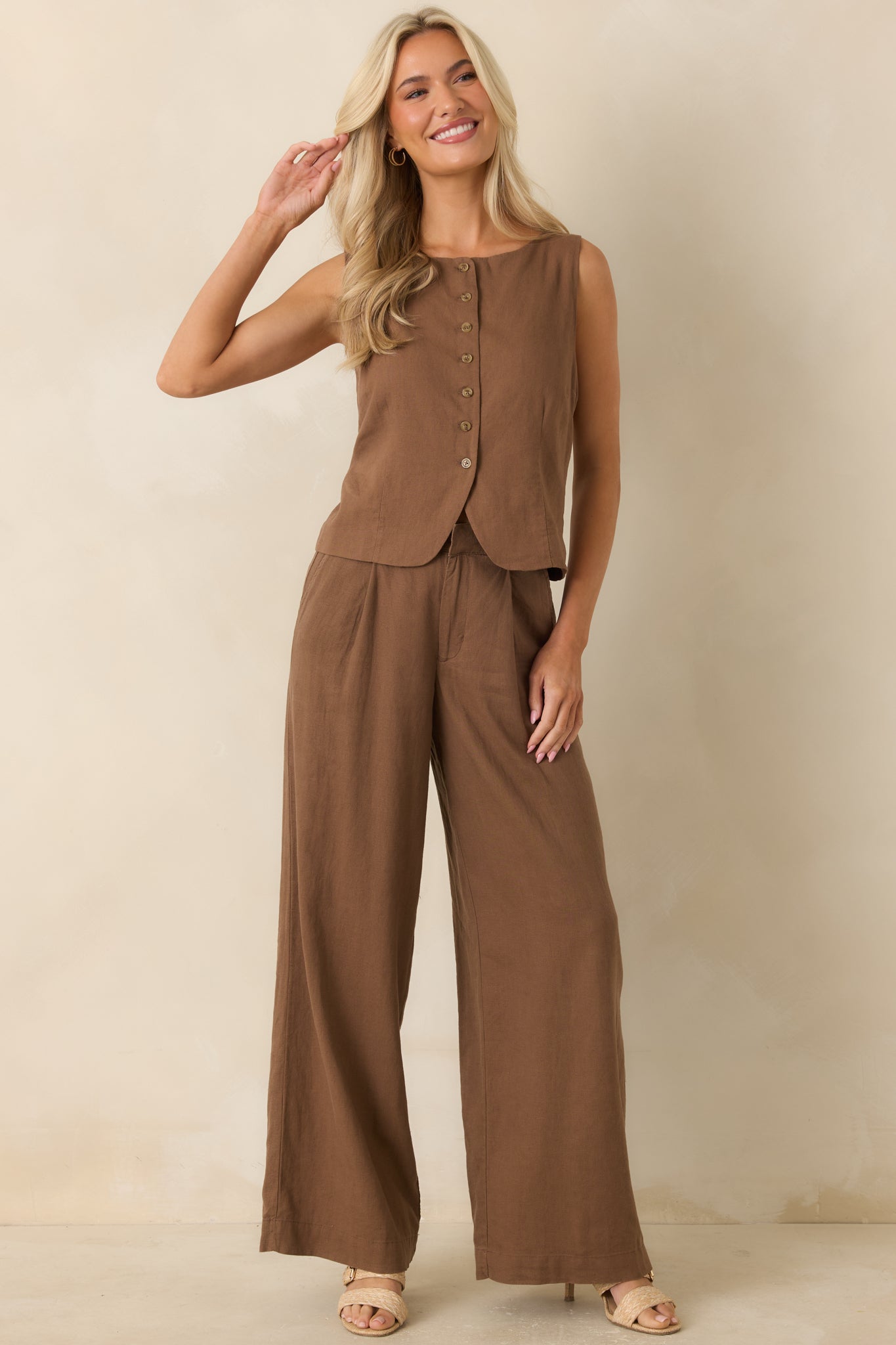 Chestnut brown sleeveless vest featuring a refined rounded neckline, button-front design, and softly structured silhouette.