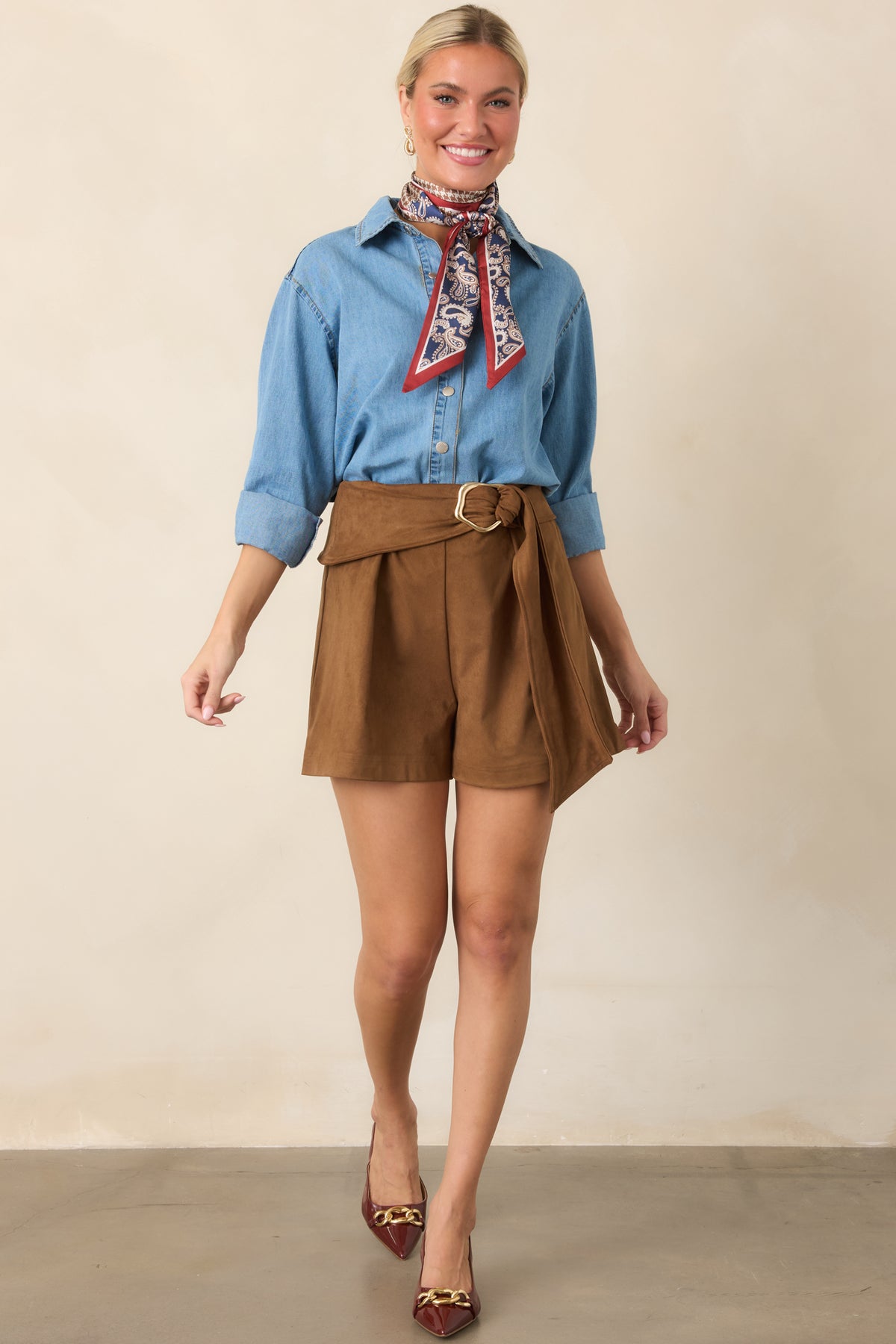 Relaxed chestnut shorts with front pleats, a statement waist belt, and long draped belt end.