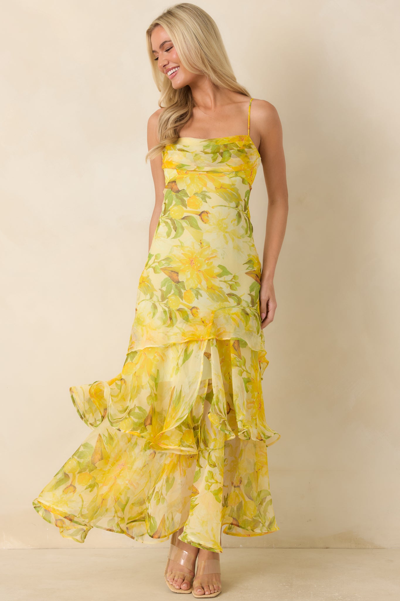 Lightweight chiffon maxi dress designed with a fitted bodice, delicate pleating, and graceful tiered movement.
