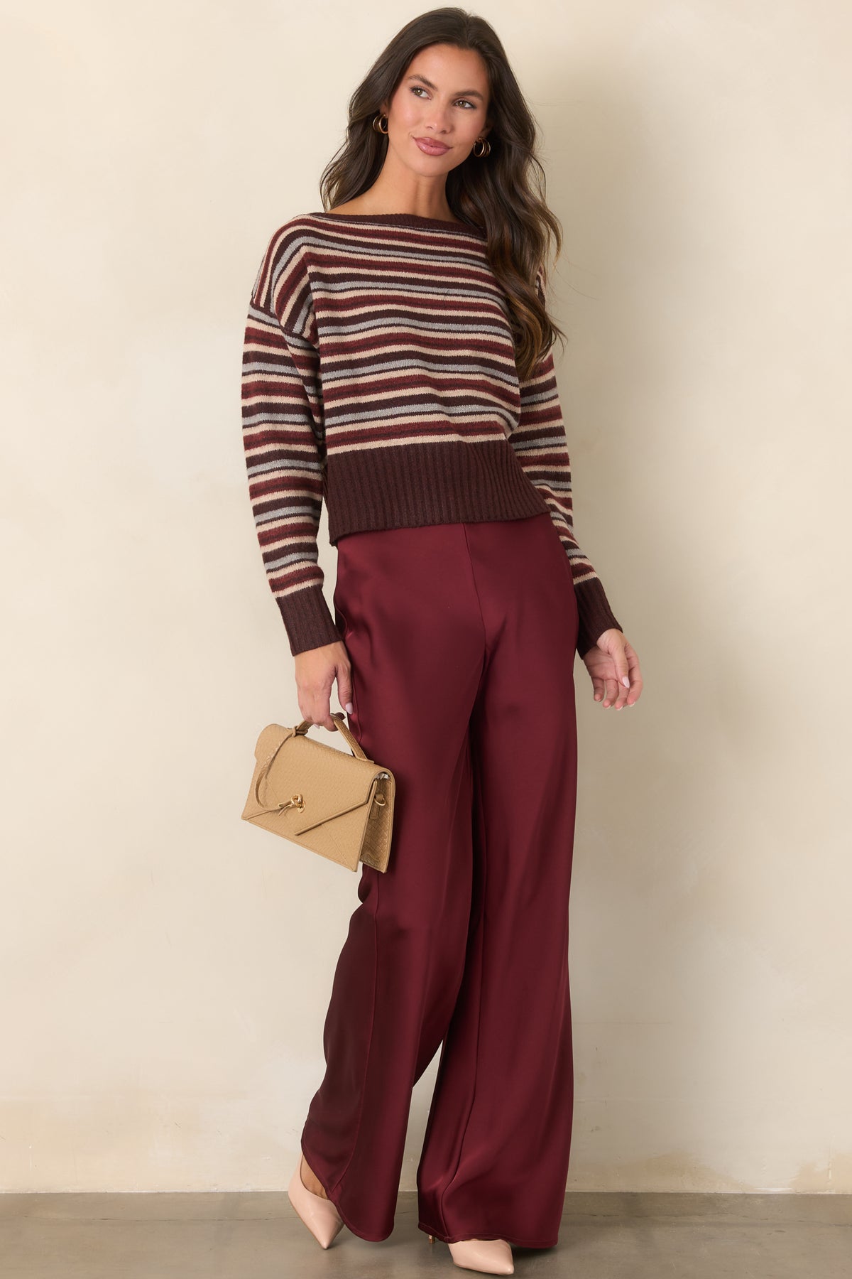  Striped knit top featuring chocolate brown, burgundy, vanilla, and grey tones with a relaxed silhouette.