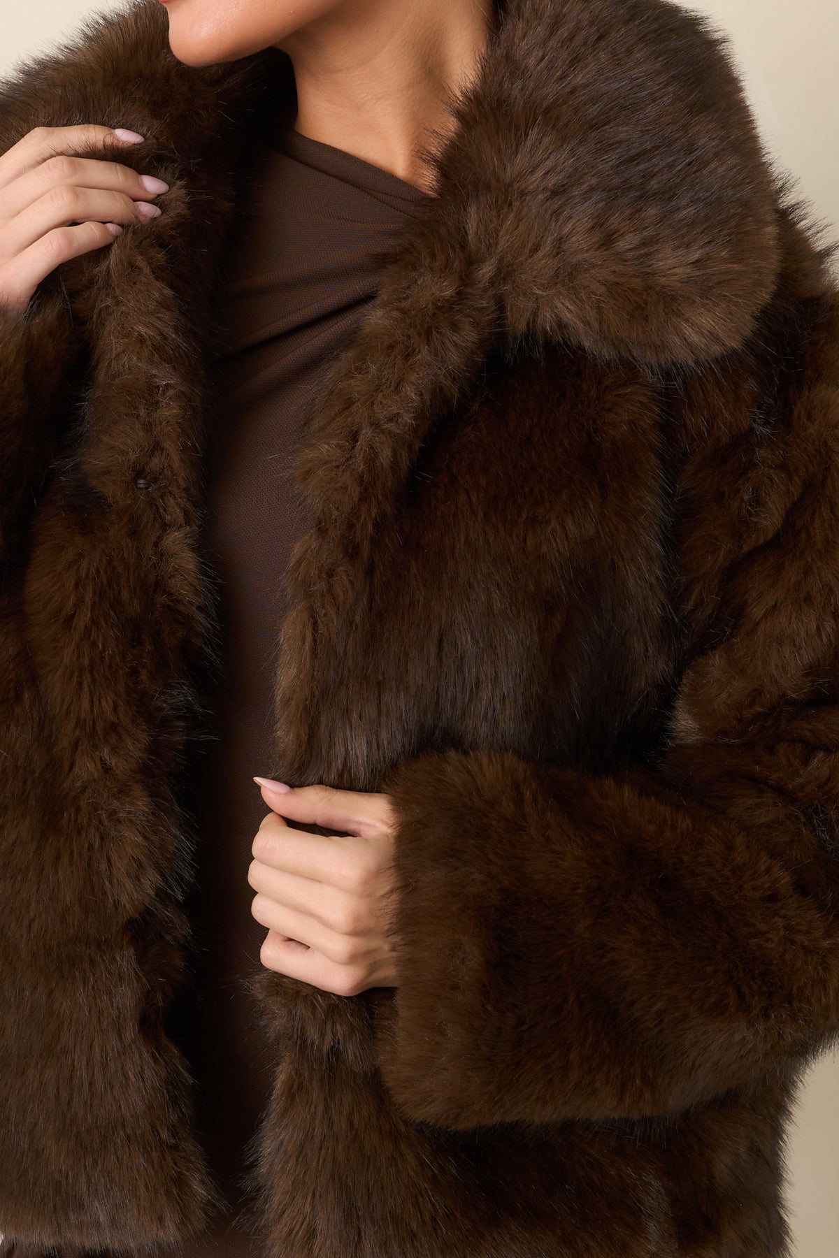 Close-up of the chocolate brown faux fur highlighting its plush texture and generous collar.
