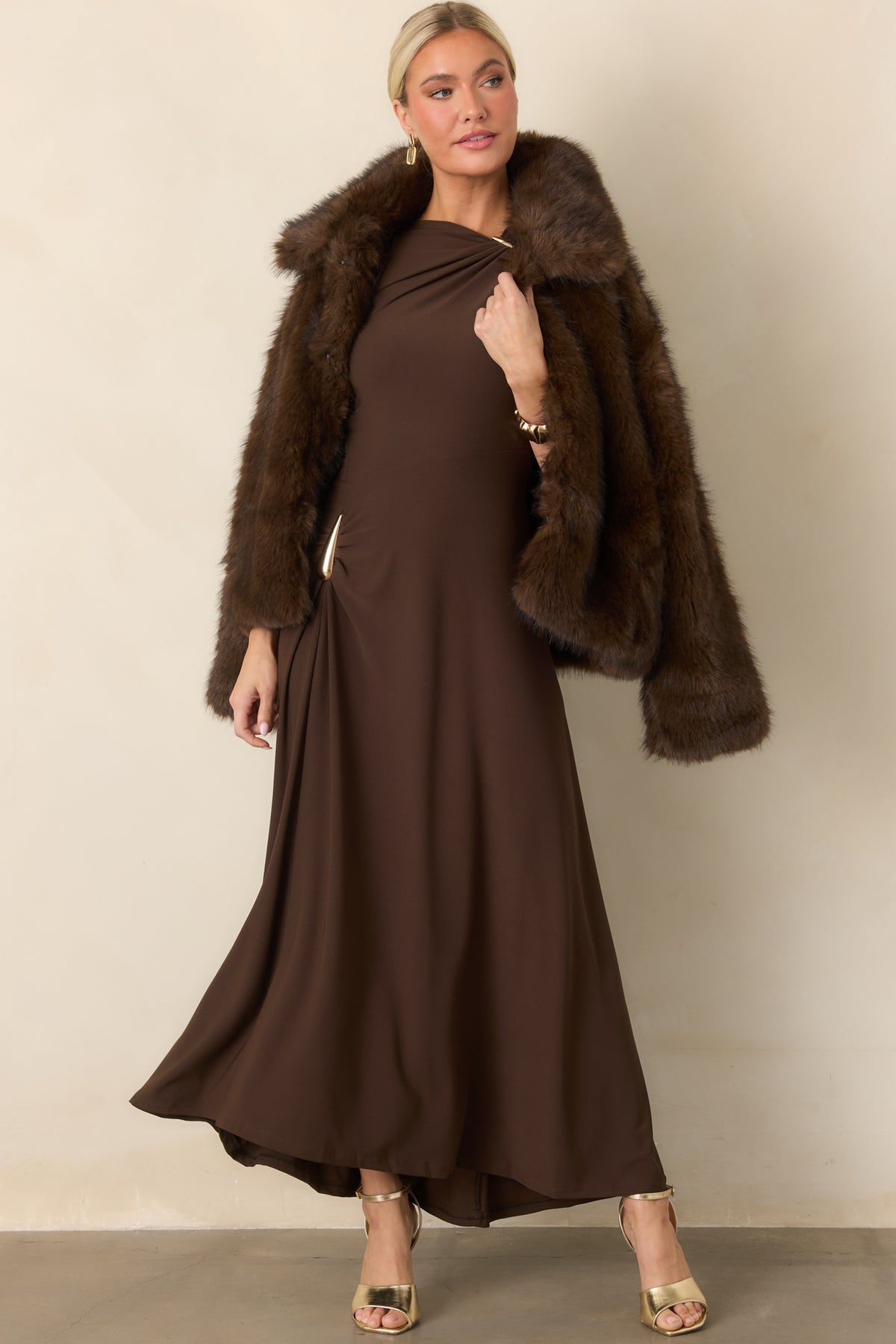 Chocolate brown faux fur jacket showcasing its relaxed shape, oversized collar, long sleeves, and lined interior.