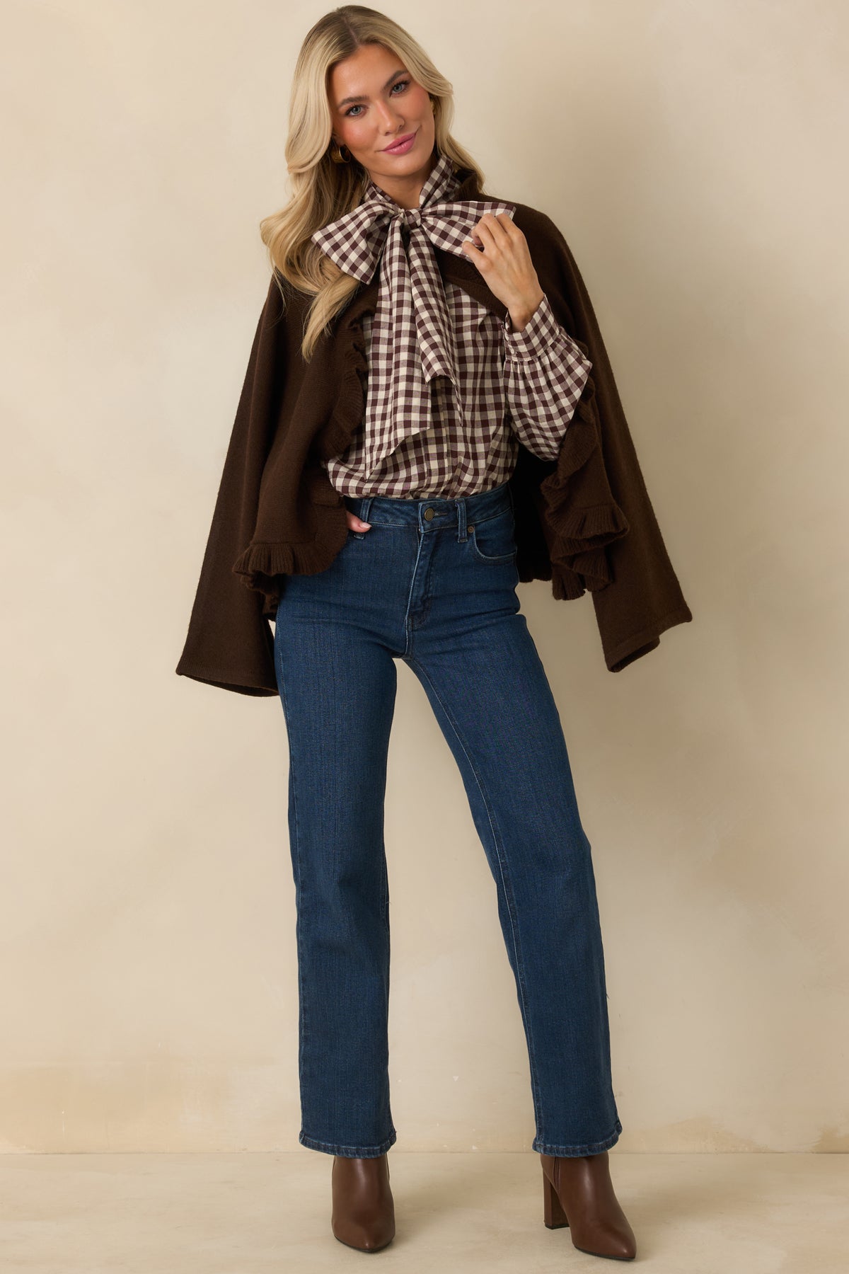 Chocolate brown and ivory check blouse with a voluminous neck bow and long sleeves.