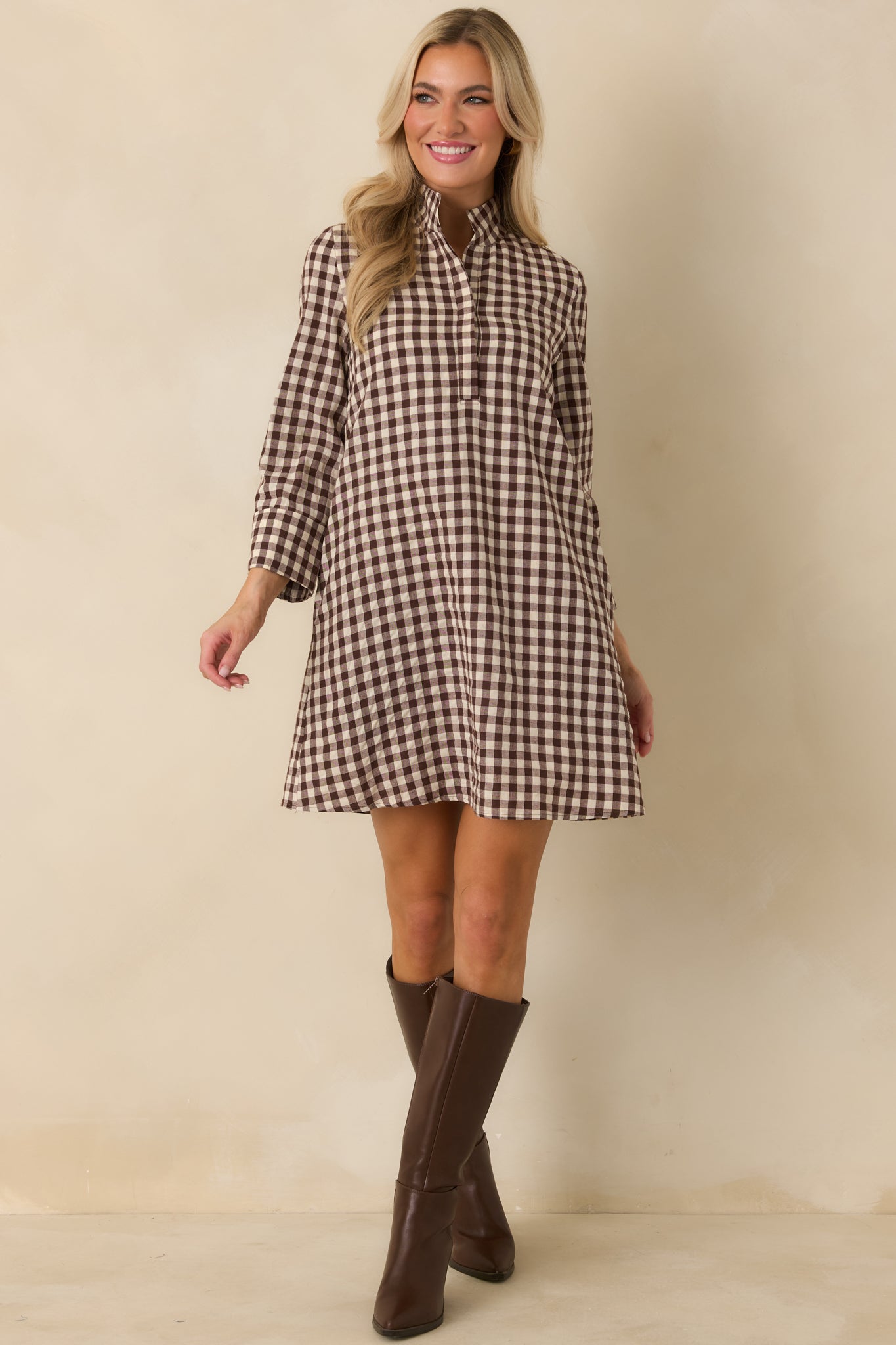 Chocolate brown and ivory gingham dress with a concealed partial button placket, three-quarter sleeves, and A-line shape.