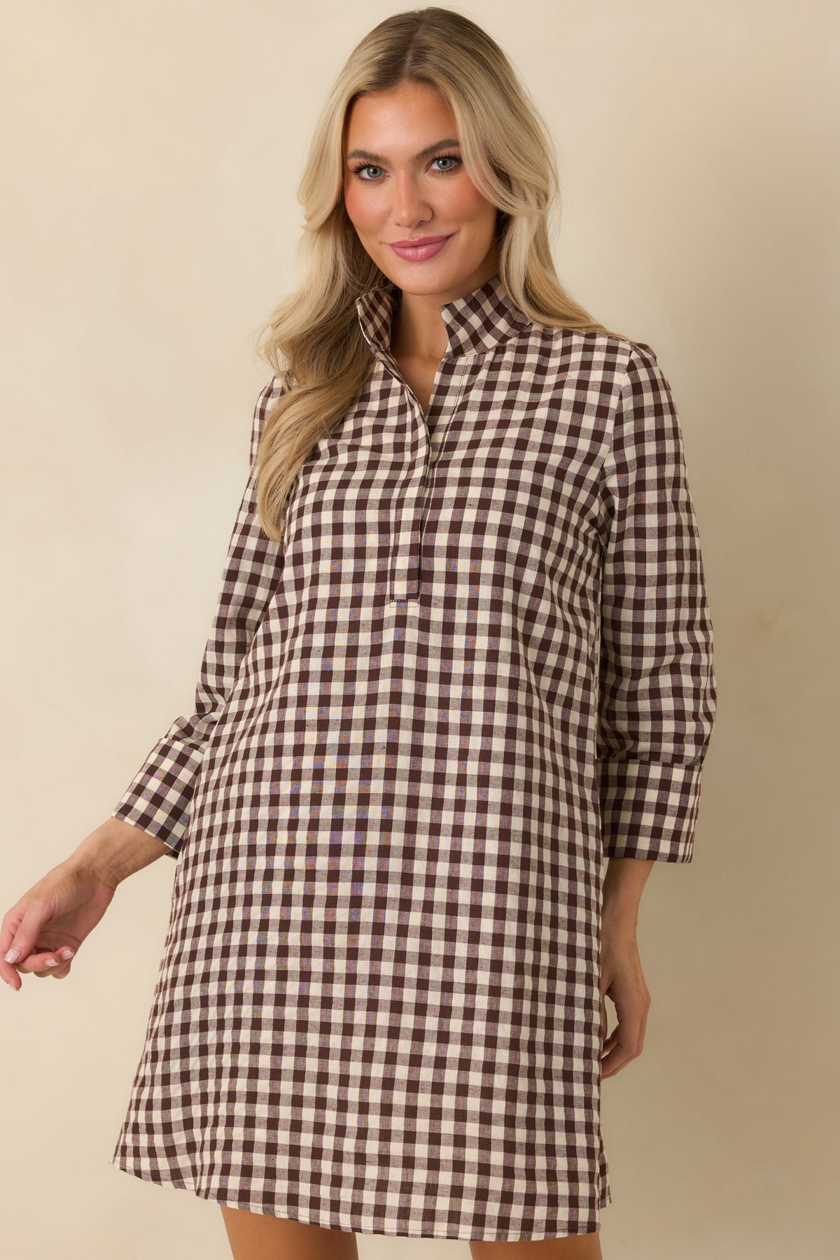Chocolate brown and ivory gingham mini dress showcasing the classic check pattern and tailored neckline.