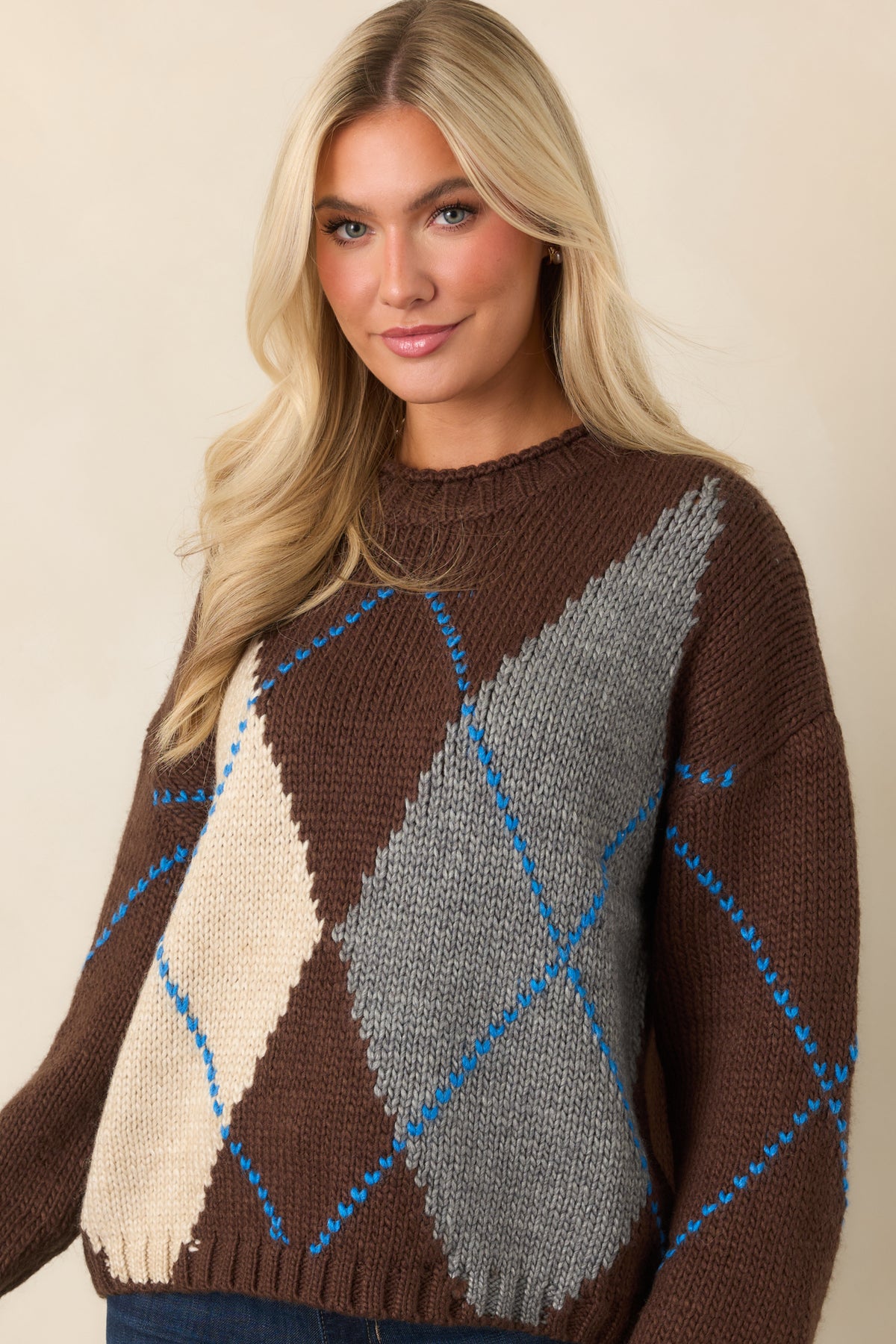 Rich chocolate brown knit with ivory and heather gray diamond blocks framed by vivid blue stitching.