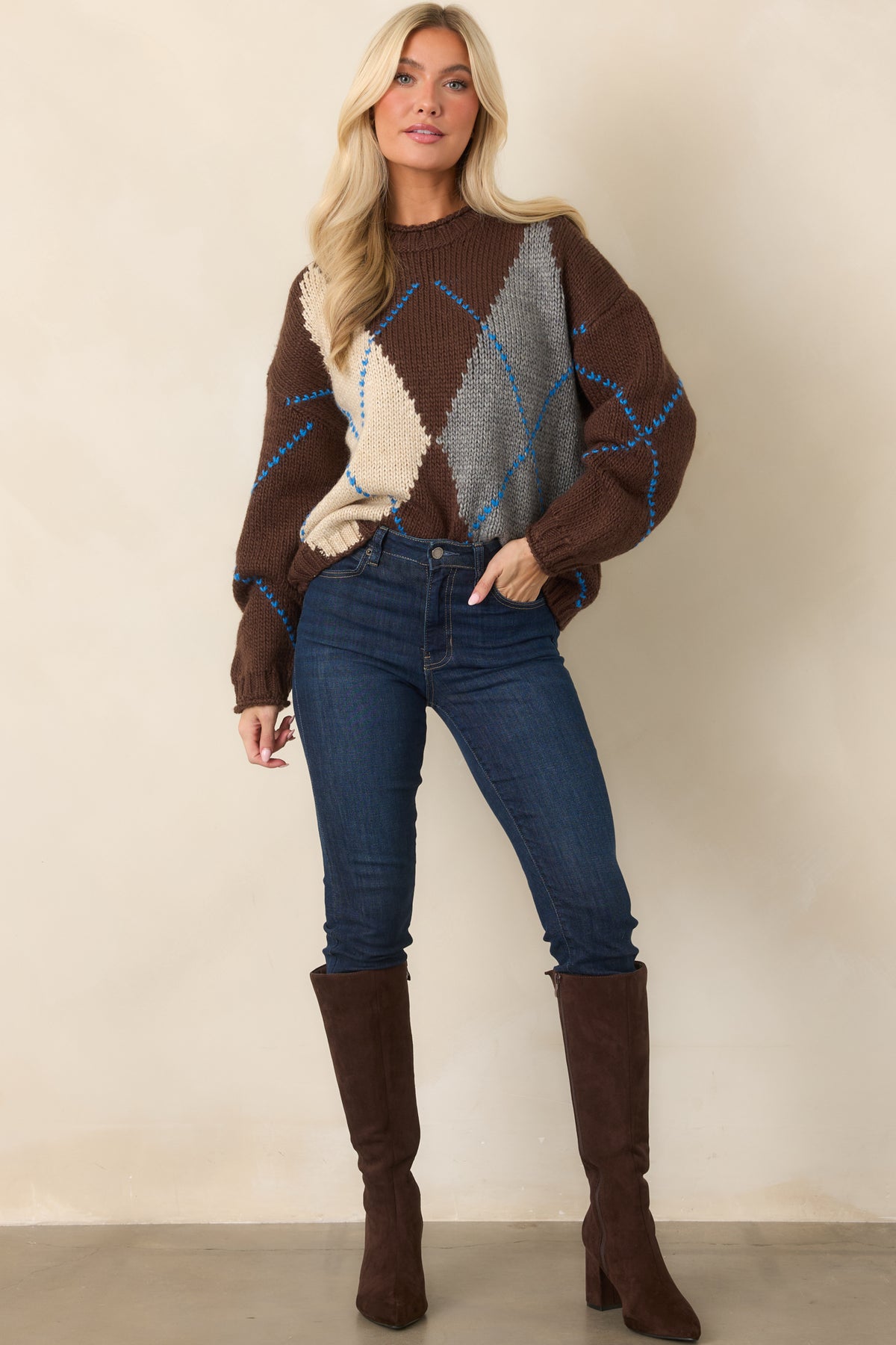 Chunky chocolate brown knit sweater with oversized ivory and heather gray diamond color blocking, blue contrast stitching, and ribbed trim.