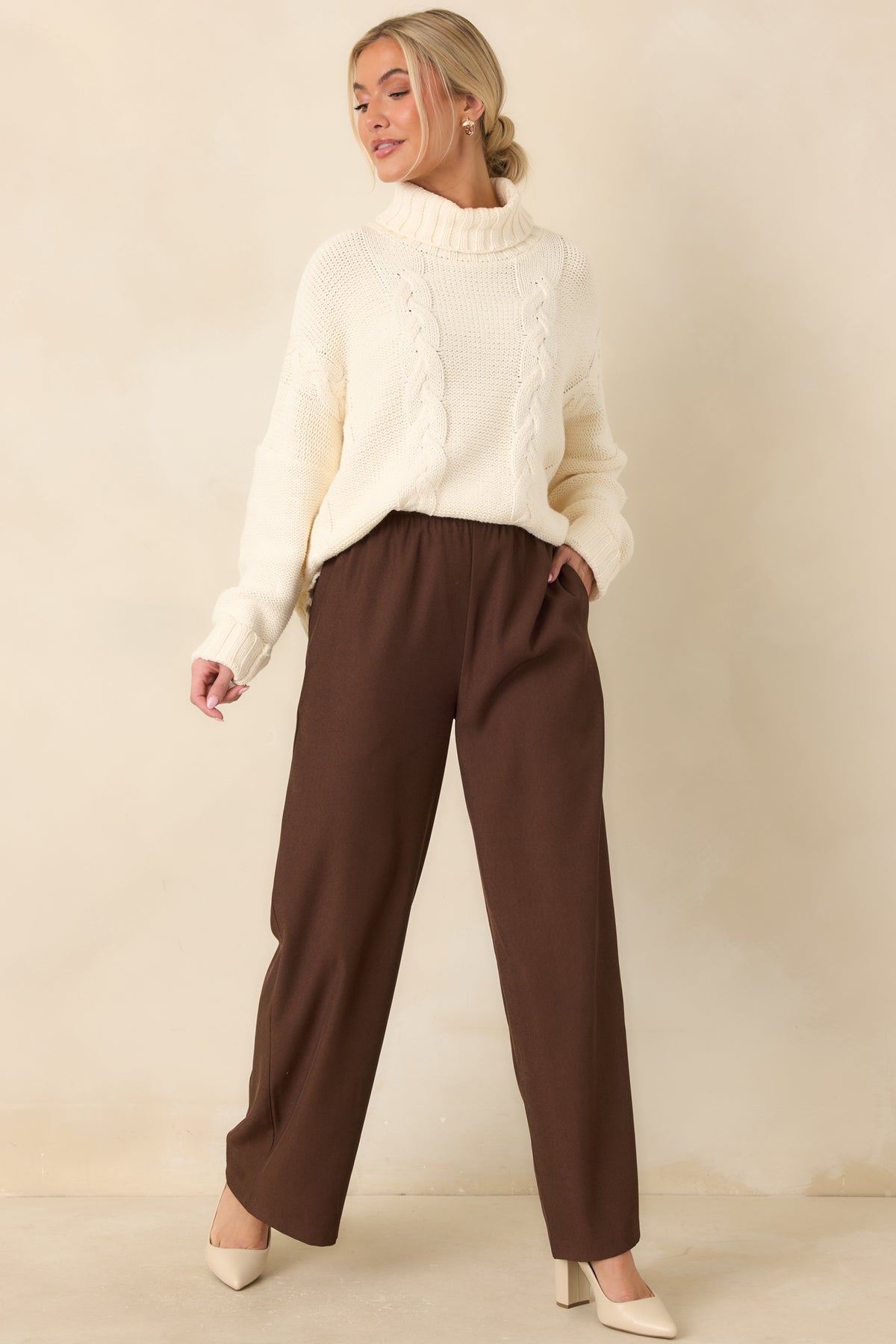 Full-length chocolate brown pants with a gathered elastic waist and a loose, flowing fit.