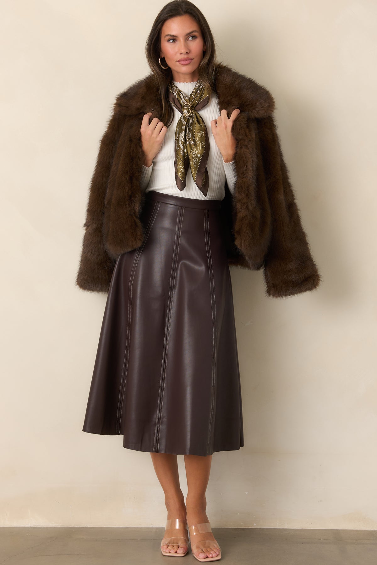Chocolate brown faux fur jacket showcasing its plush texture, long sleeves, generous collar, and relaxed shape.