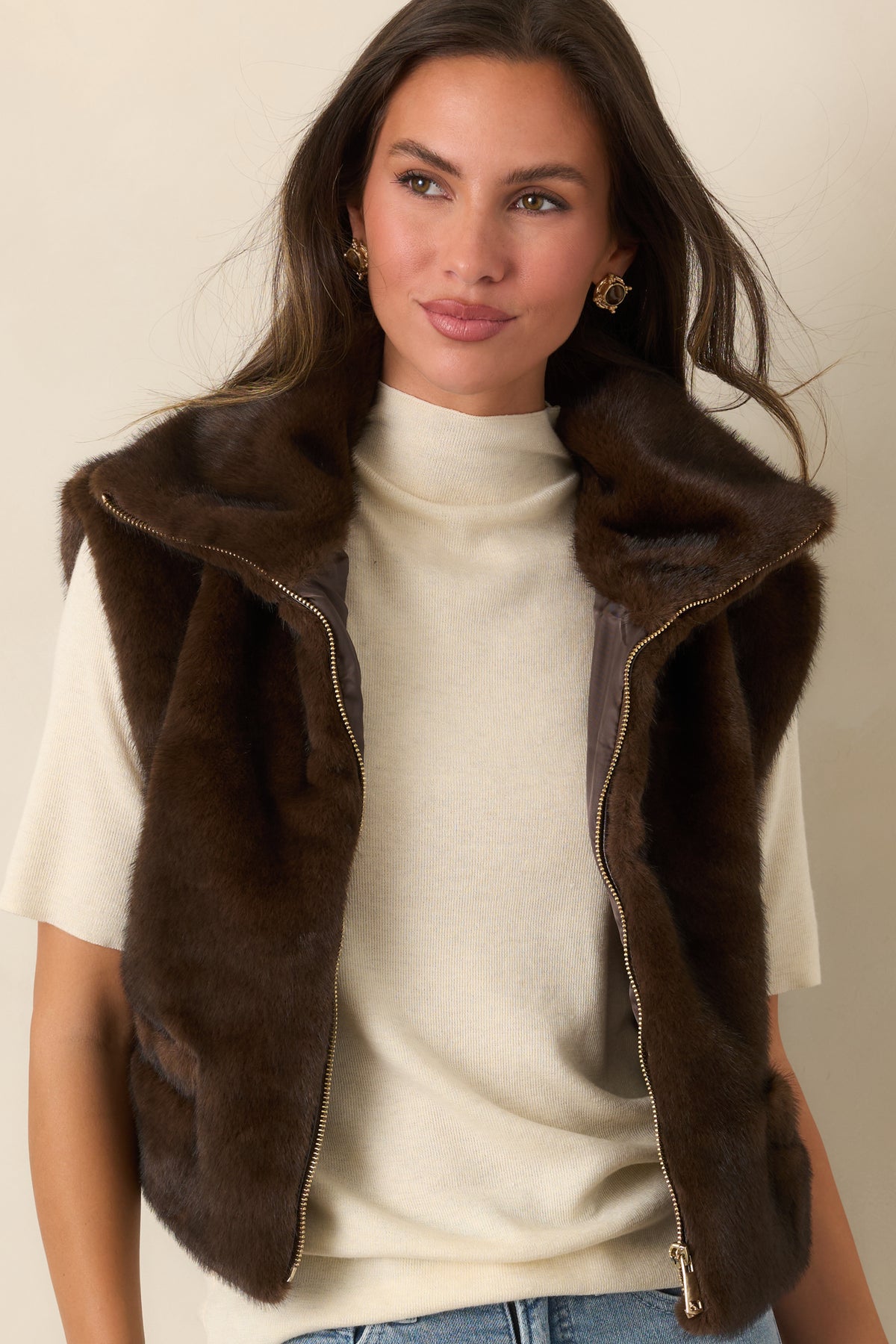 Chocolate brown plush vest with a relaxed opening, oversized collar, and functional front pocket.