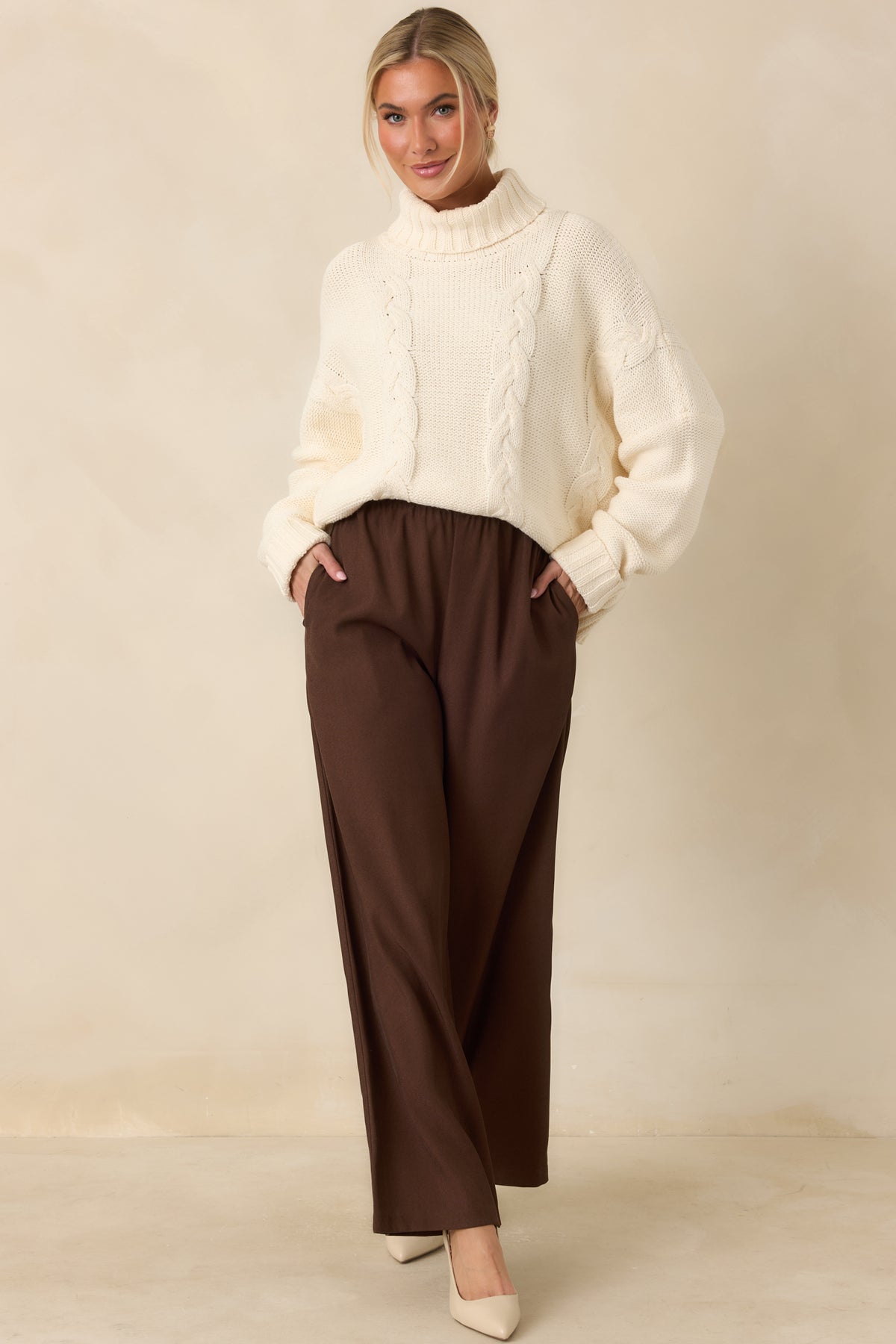 Relaxed chocolate brown trousers featuring roomy wide legs and functional side pockets.