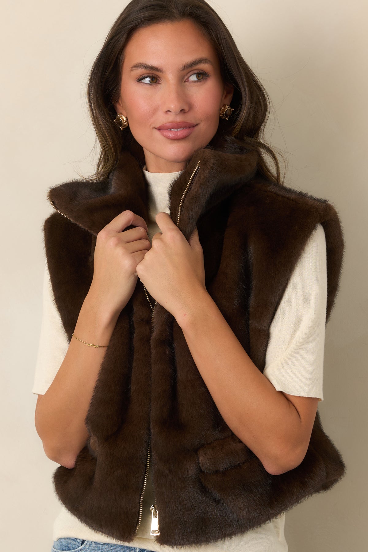 Soft faux fur vest highlighting the silver-tone zipper against its rich chocolate brown finish.