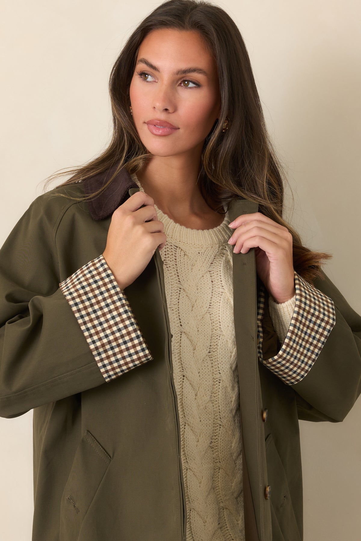 Chocolate brown corduroy collar and checked contrast cuffs accent the smooth canvas-feel coat.
