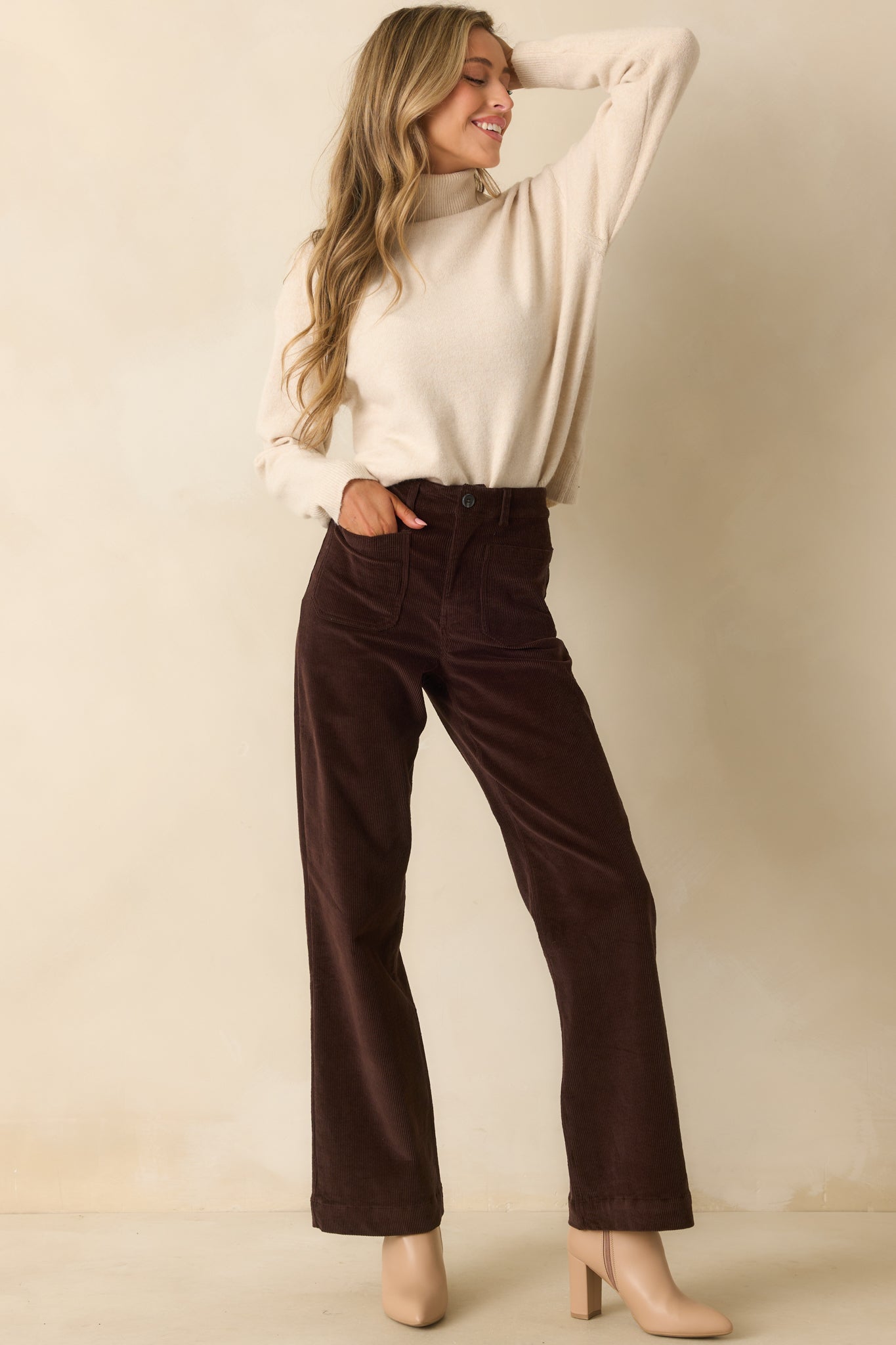 Chocolate brown corduroy pants in a high-rise fit with straight legs, showing full length from waist to hem.