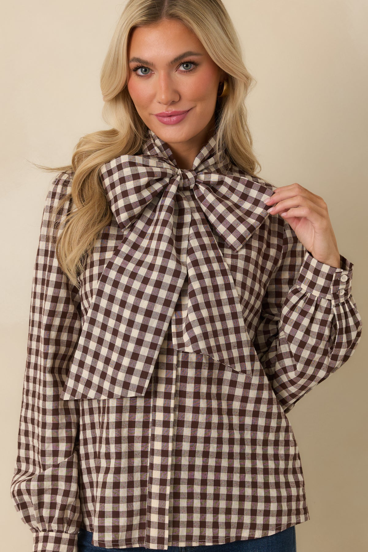 Chocolate and ivory gingham blouse with an oversized bow tied at the neckline and structured cotton-blend fabric.