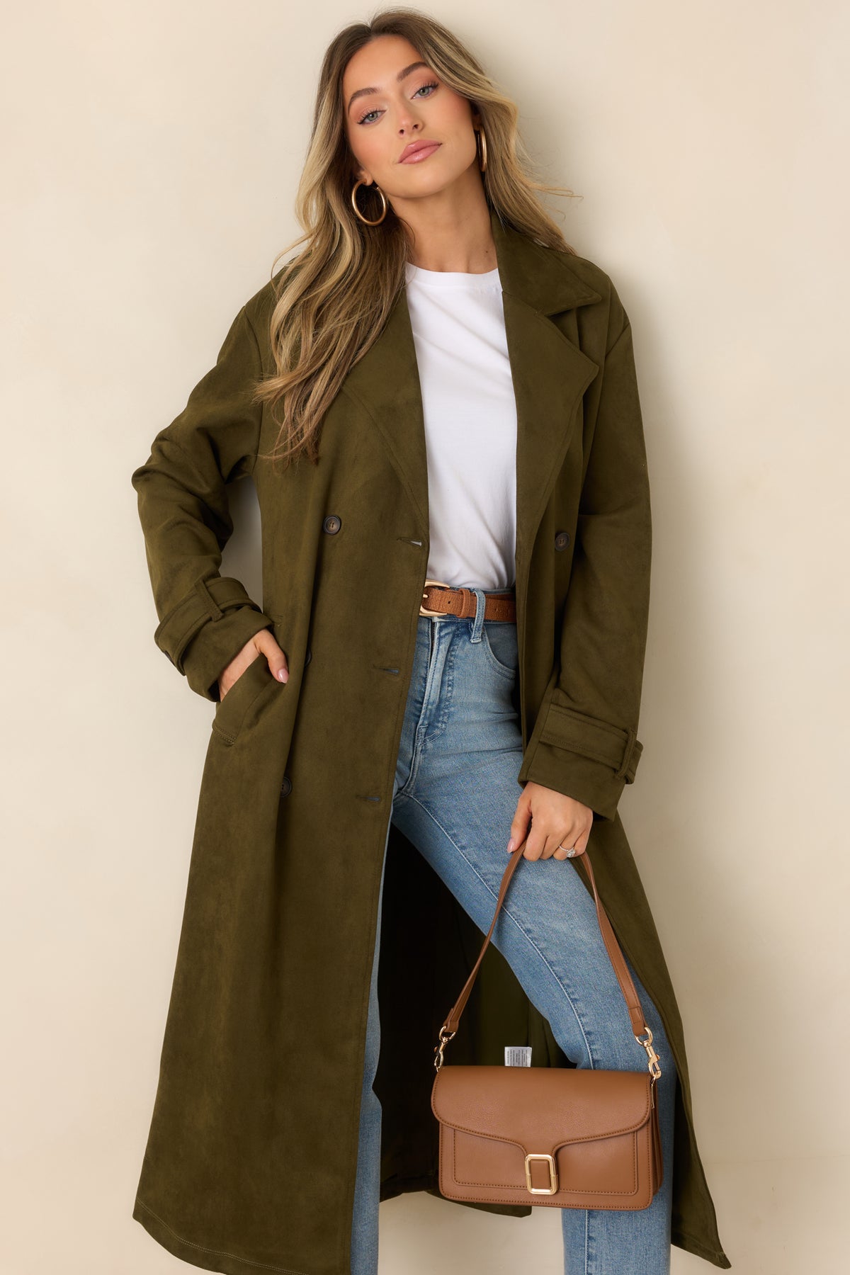 Classic belted coat with a longline cut, notched lapels, and a double-breasted button front.