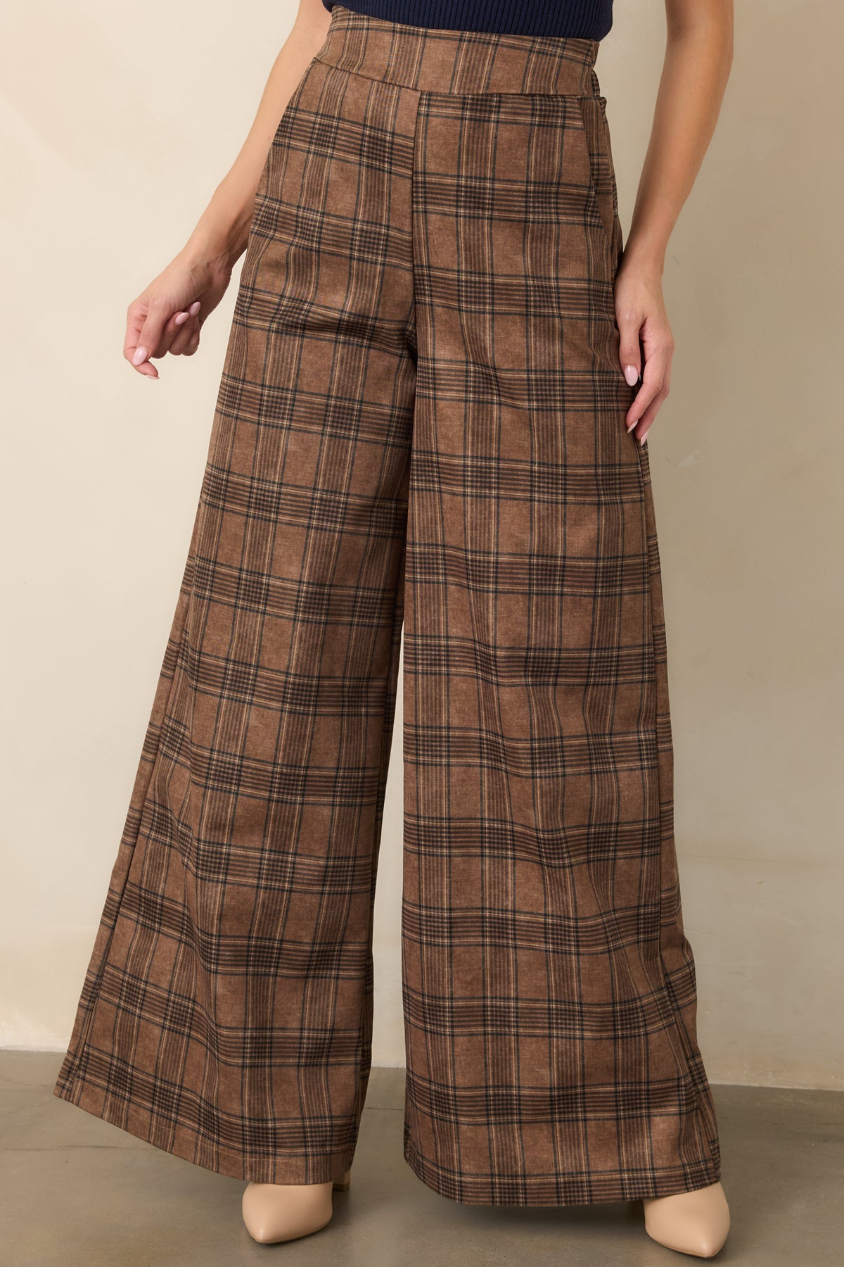 Classic plaid trousers showcasing the rich brown pattern, smooth drape, and softly structured wide-leg design.