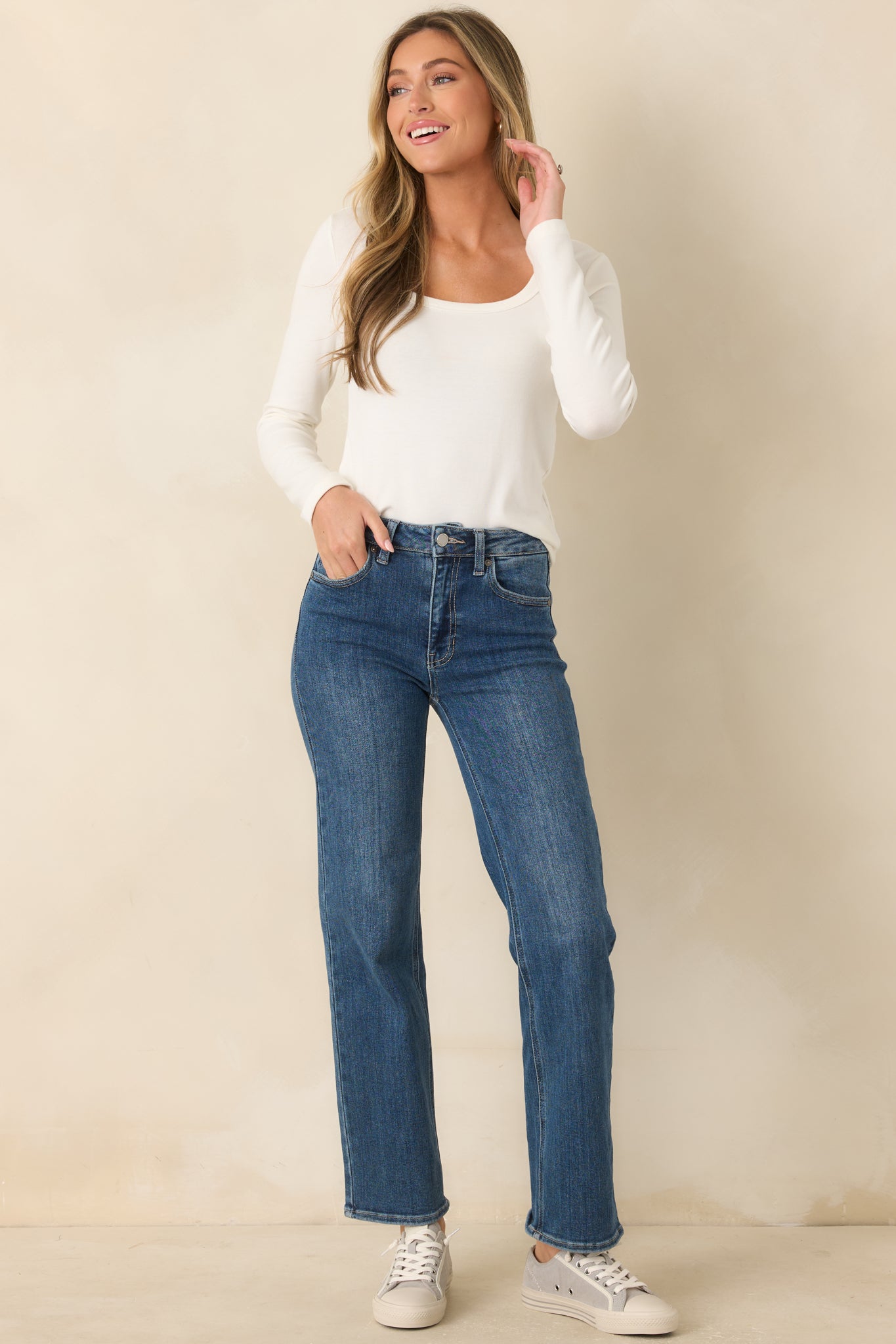 Classic ivory top showcasing a fitted shape, long sleeves, and versatile lightweight layering style.
