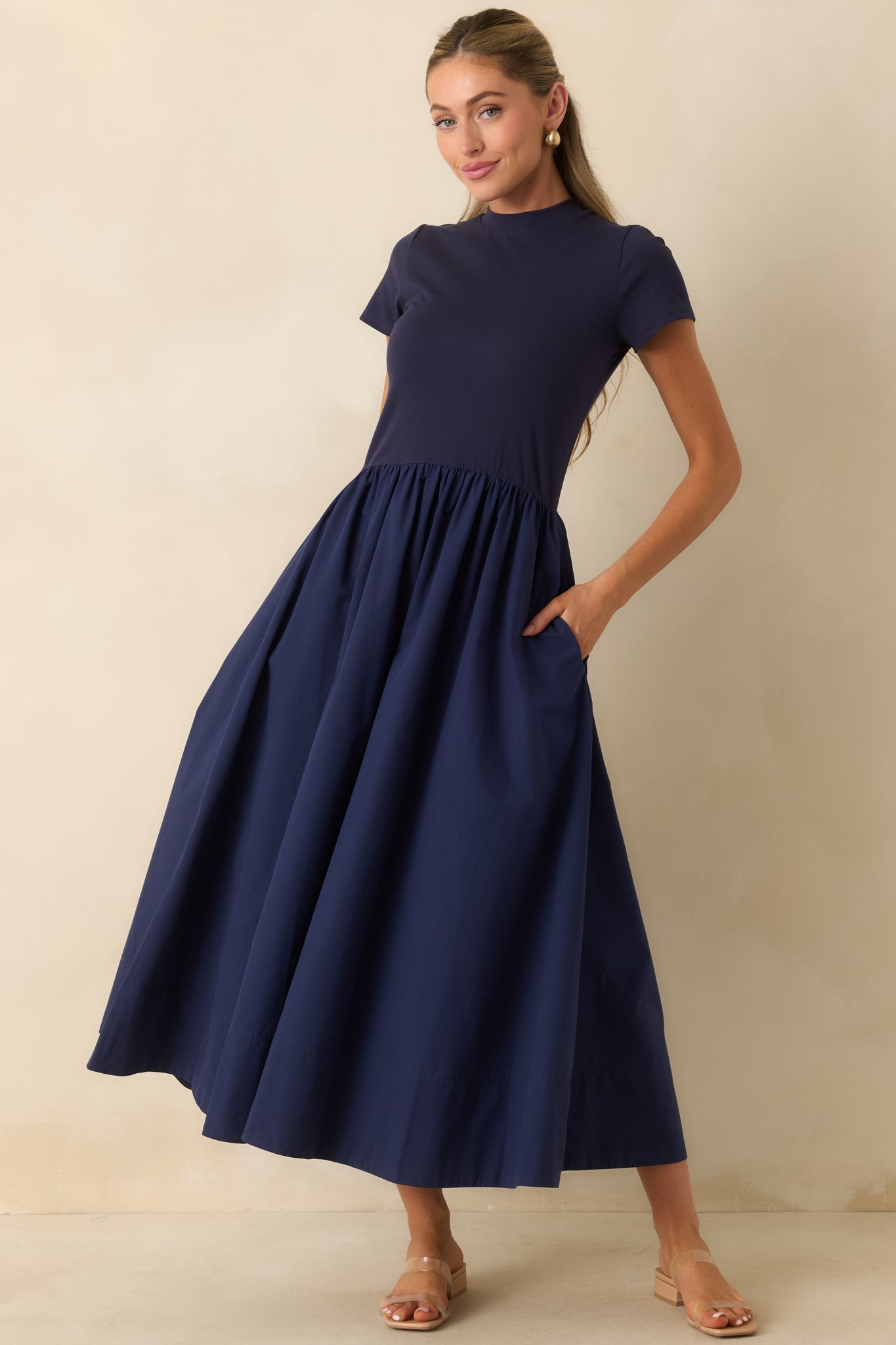 Classic midi dress designed with a clean silhouette, mock neckline, and soft gathered skirt for timeless style.