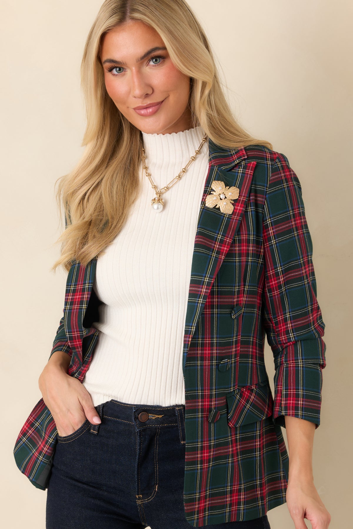 Classic red plaid pattern across a tailored blazer with structured lapels and a clean front opening.