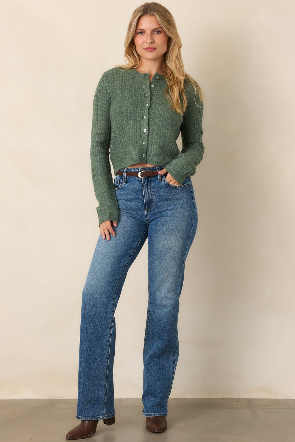 Classic knit cardigan with a soft stretch construction, tonal buttons, long sleeves, rounded neckline, and slightly cropped hemline.