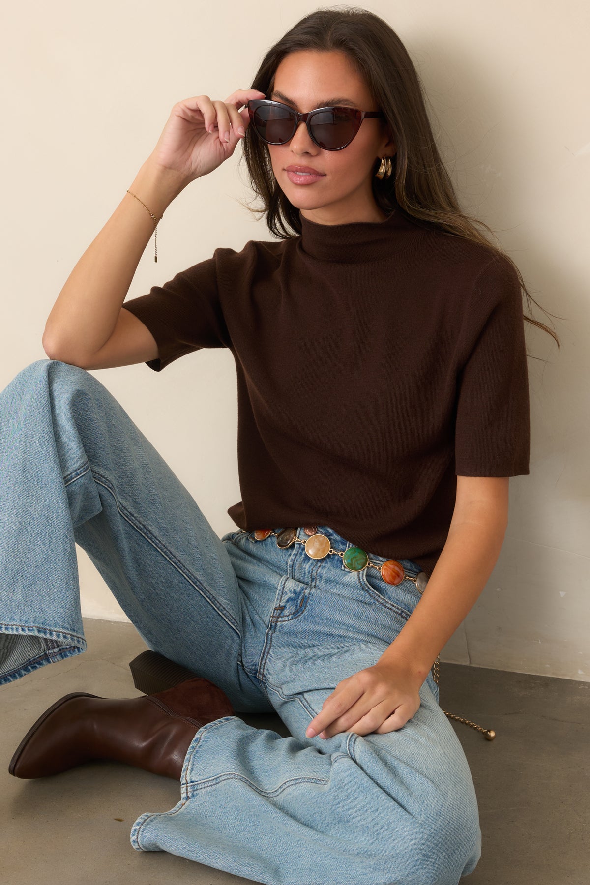 Clean knit silhouette finished with a tall turtleneck and short sleeves.
