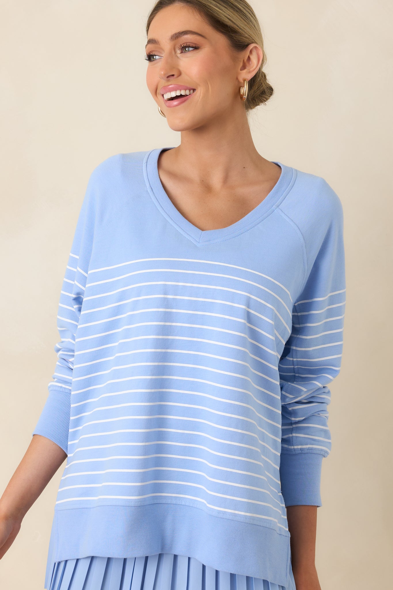 Closer angle emphasizing raglan long sleeves and the relaxed oversized drape of the top.