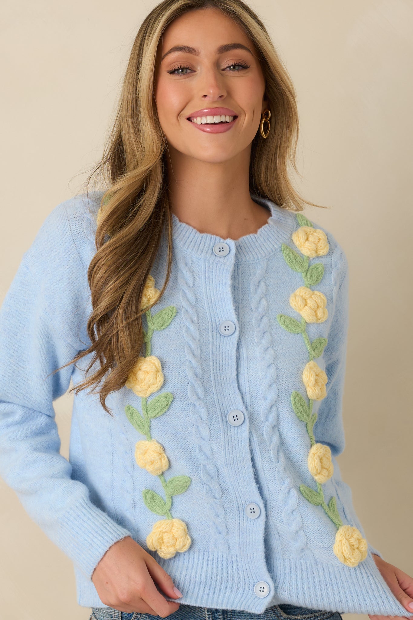 Close crop of sleeve and torso emphasizing ribbed cuff and detailed raised floral design.