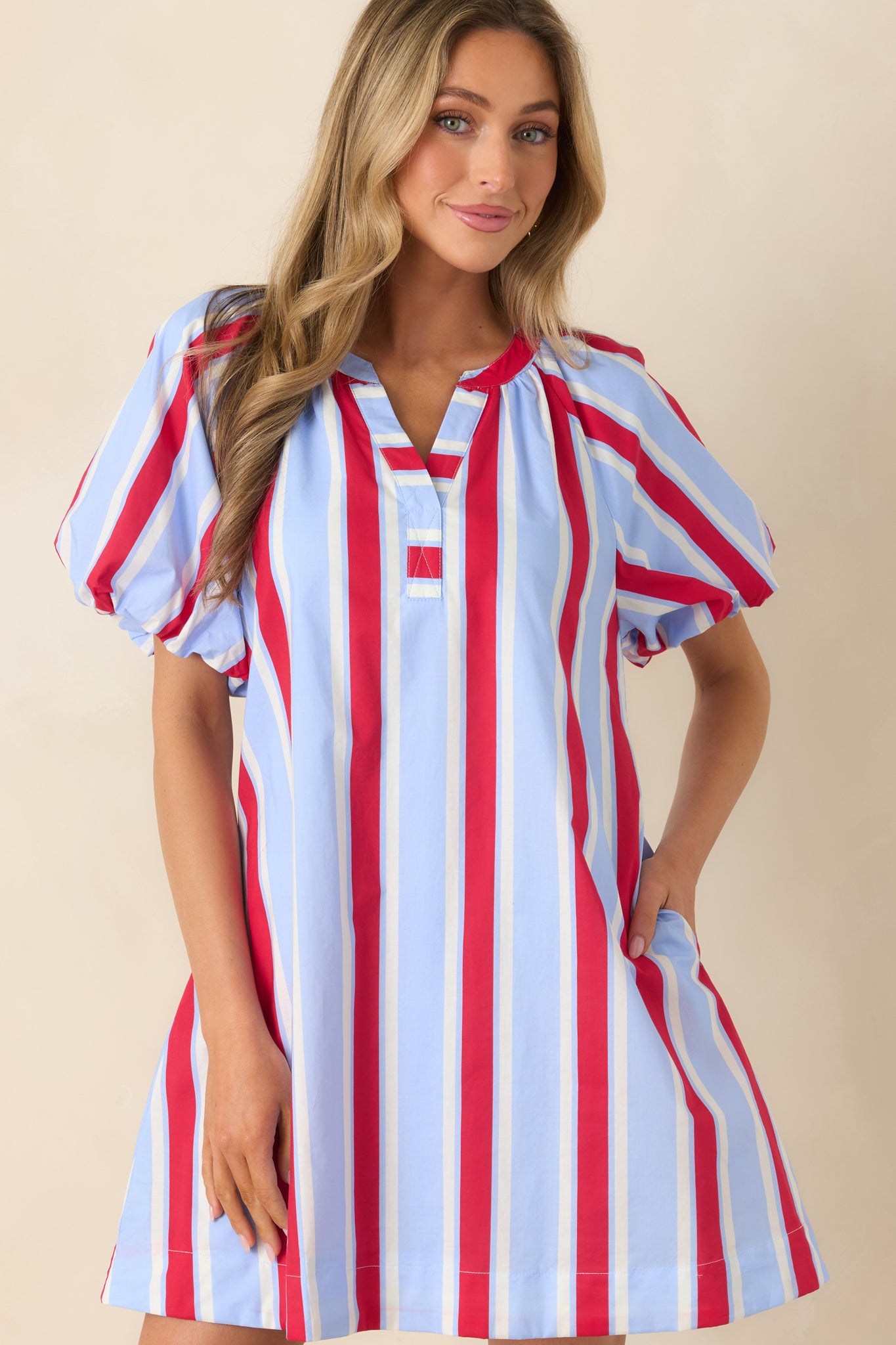 Close cropped detail of the elasticized sleeve and soft cotton fabric texture on the striped mini dress