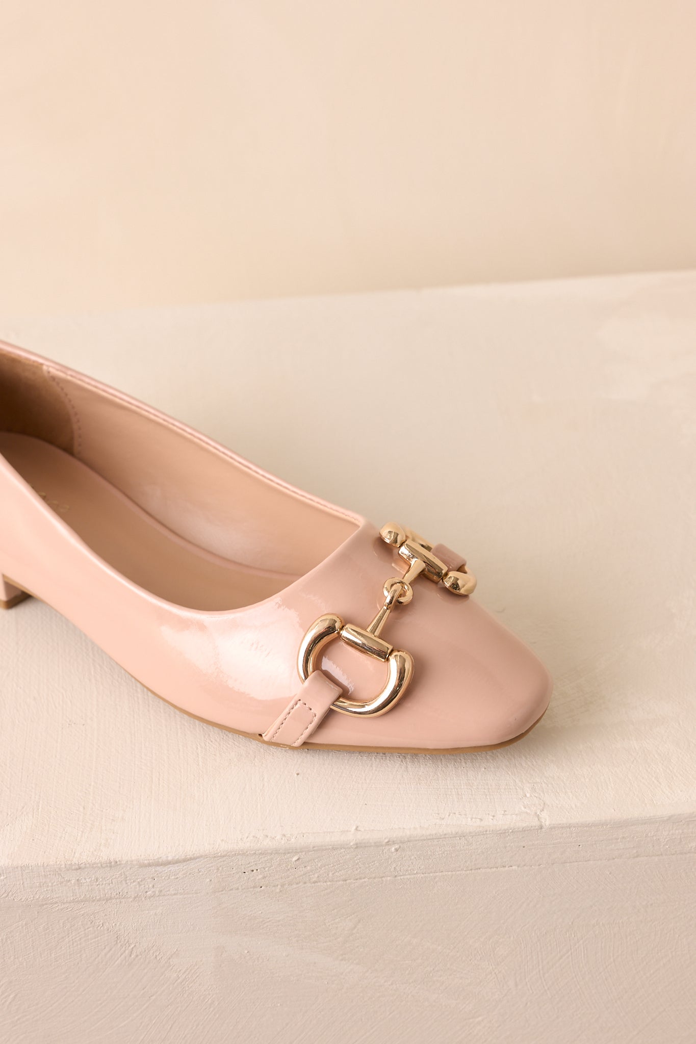 Close-up detail of the gold horsebit hardware and stitching on the vamp of the loafers.