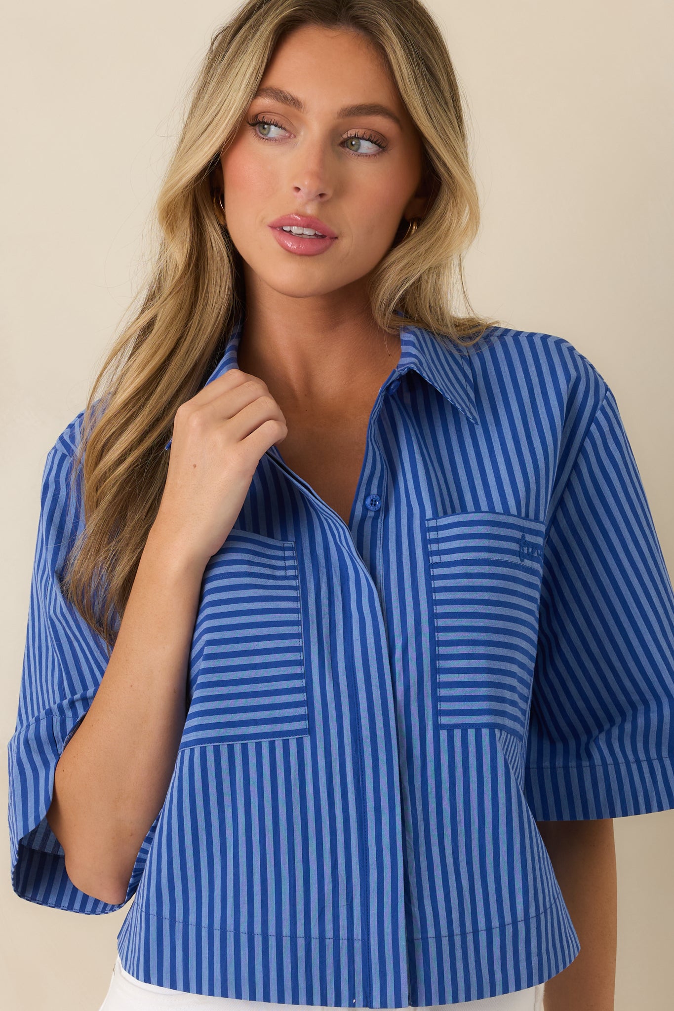 Close look at the playful mixed-direction stripes and polished collar detail of the cropped top.