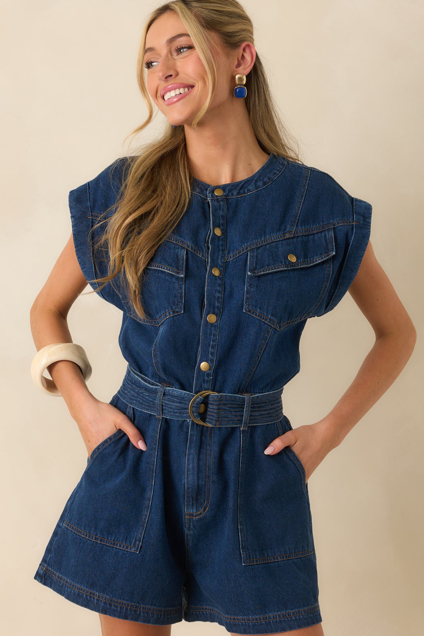 A close cropped shot showcasing the self-tie belt at the waistline of the romper.
